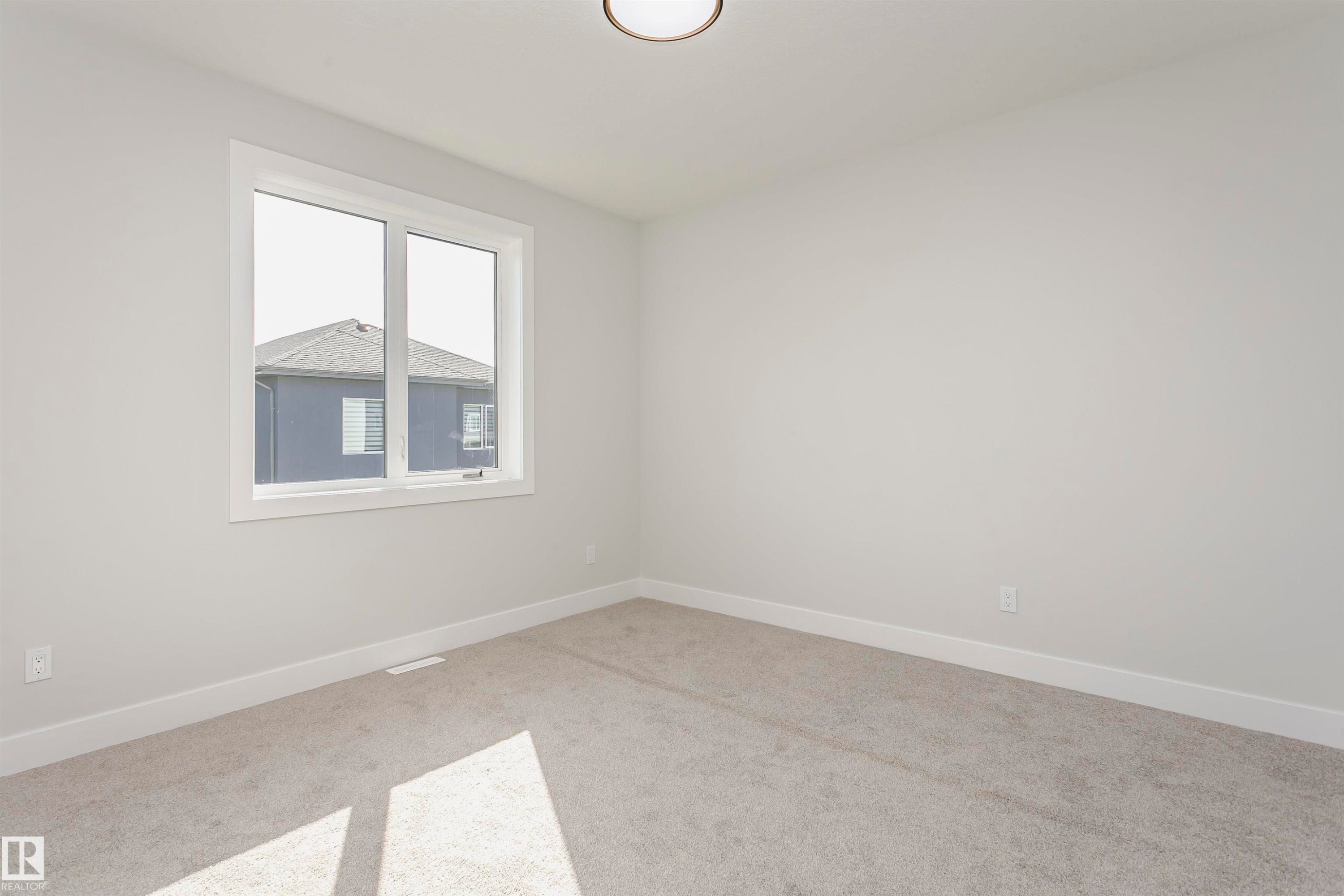 Unfurnished room featuring carpet floors and baseboards - 1723 19 Street, Edmonton, AB - Indoor Photo Showing Other Room