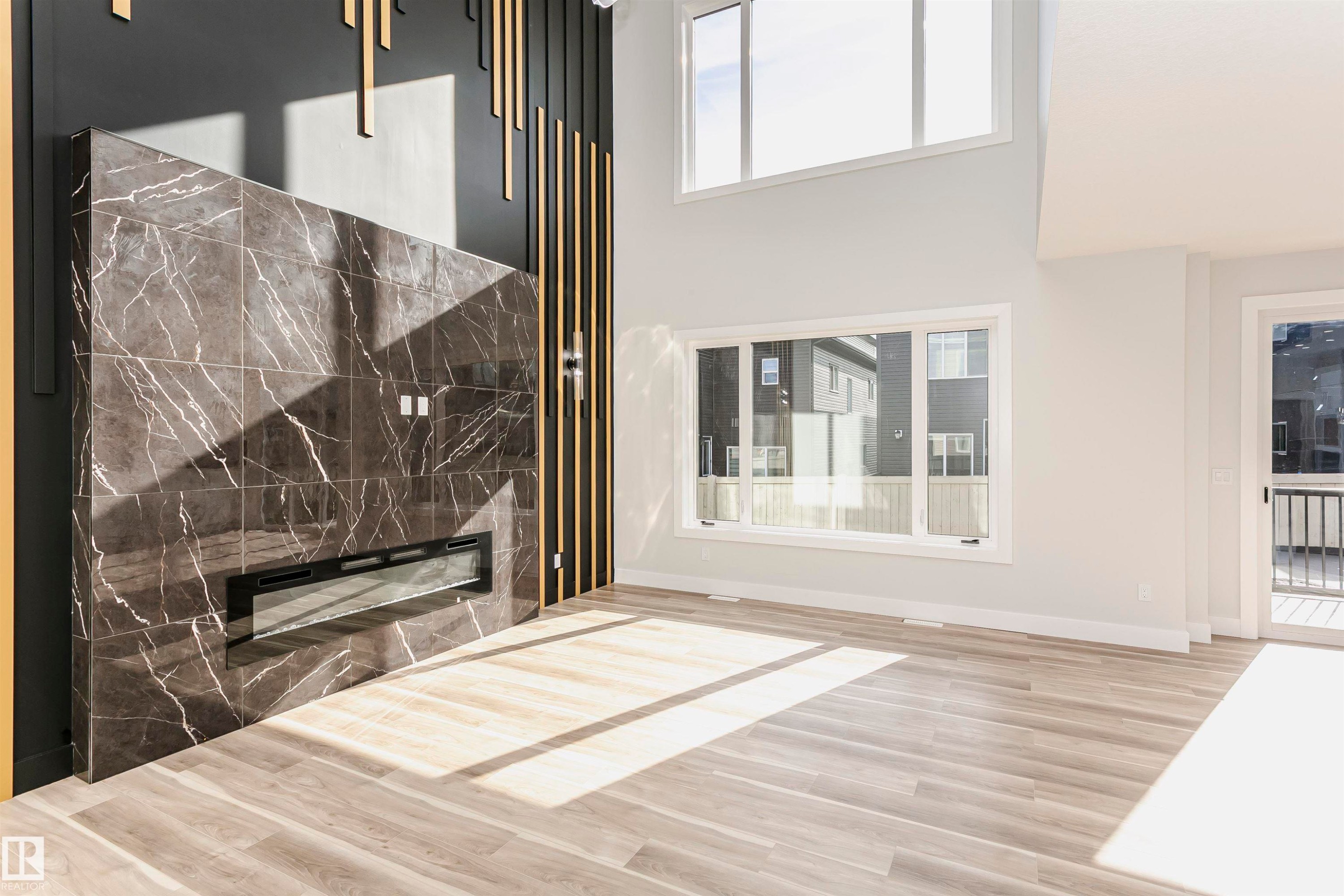 Detailed view of LVP finished floors and a premium fireplace - 1723 19 Street, Edmonton, AB - Indoor Photo Showing Other Room With Fireplace