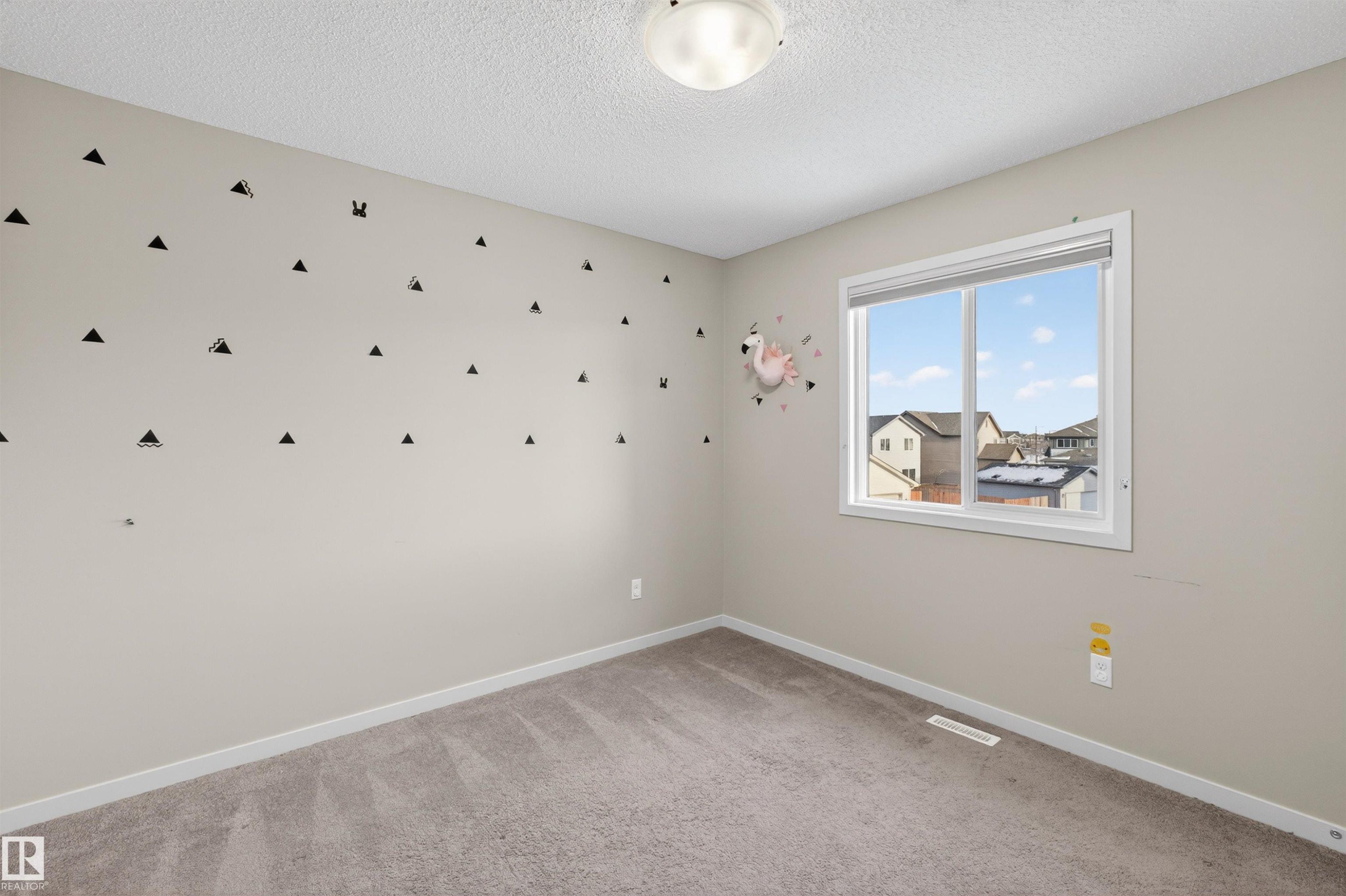 Unfurnished room with light colored carpet and a textured ceiling - 4723 Alwood Bend Bend Sw, Edmonton, AB - Indoor Photo Showing Other Room