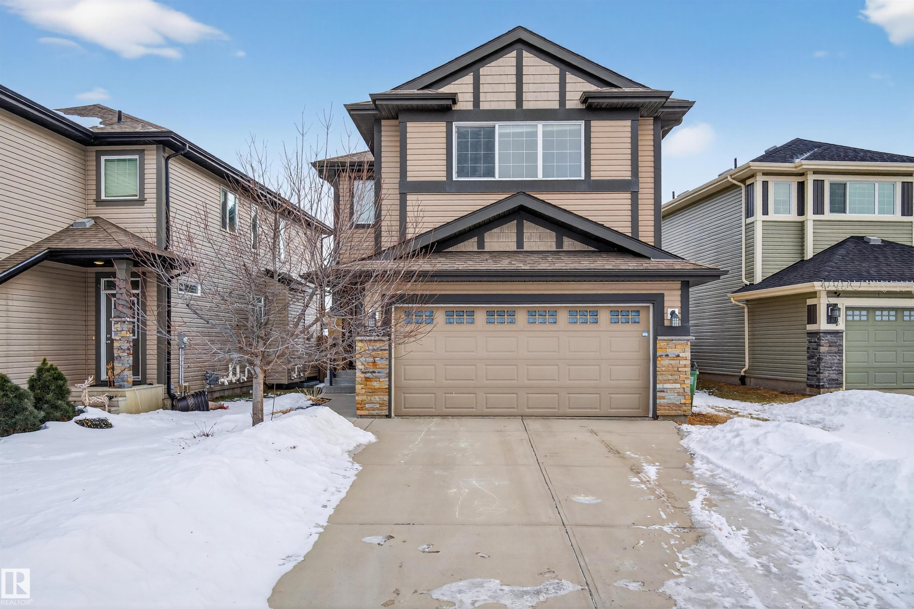 Craftsman inspired home with stone siding, an attached garage, and driveway - 4723 Alwood Bend Bend Sw, Edmonton, AB - Outdoor With Facade