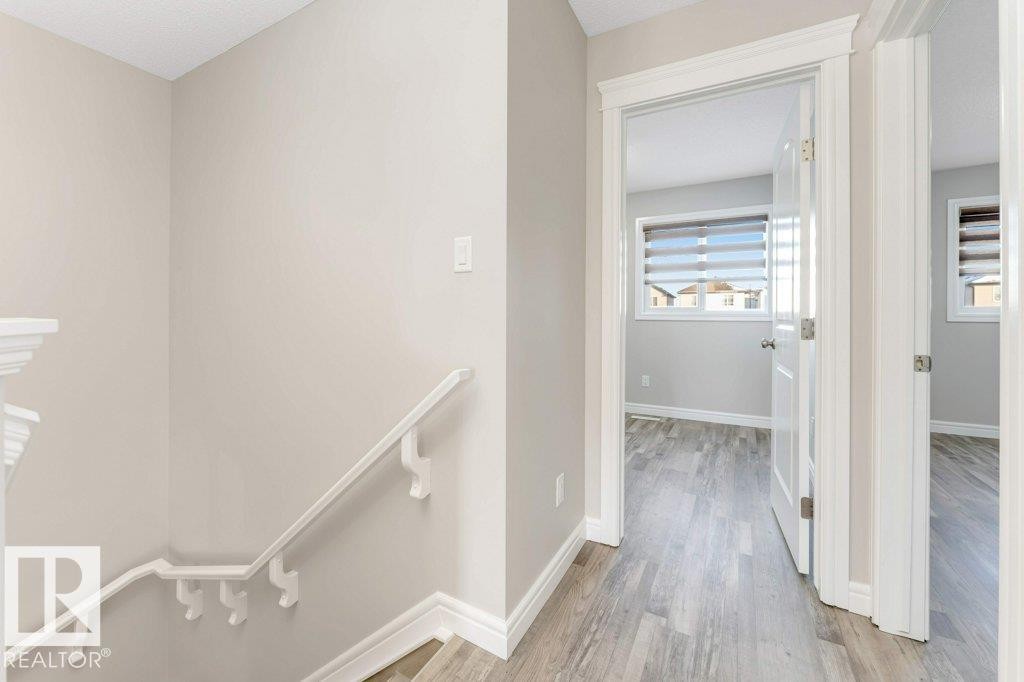 Hallway featuring an upstairs landing and light wood finished floors - 1423 24 Street, Edmonton, AB - Indoor Photo Showing Other Room