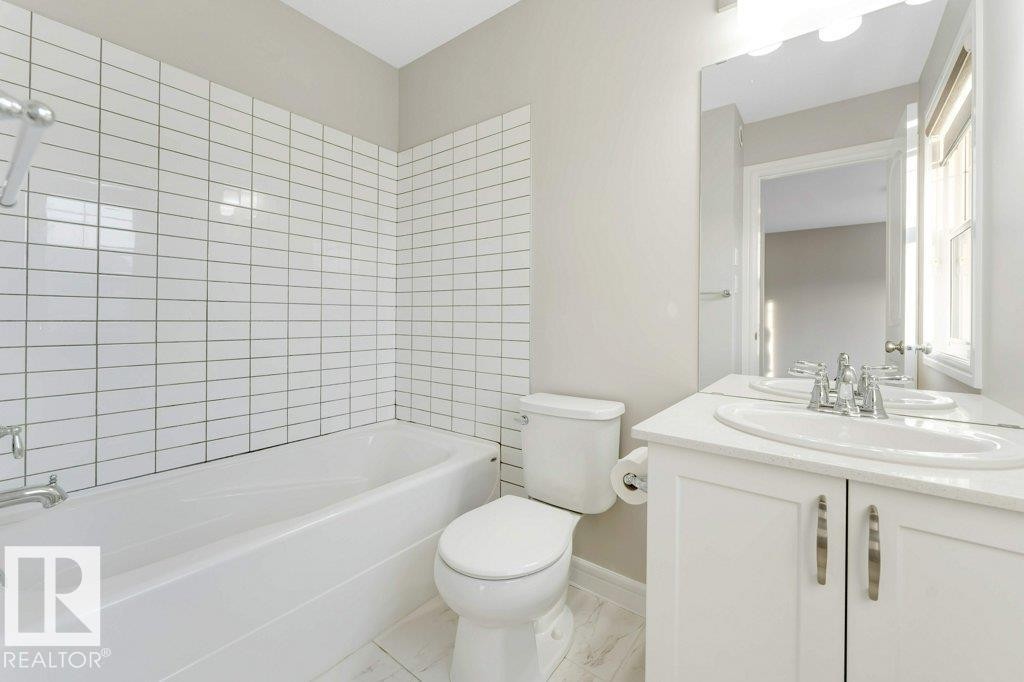 Bathroom with vanity and shower / washtub combination - 1423 24 Street, Edmonton, AB - Indoor Photo Showing Bathroom
