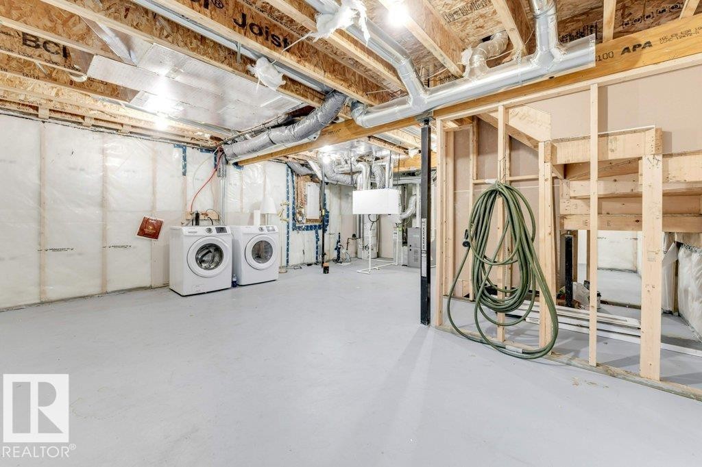 Unfinished basement featuring washer and clothes dryer and electric panel - 1423 24 Street, Edmonton, AB - Indoor