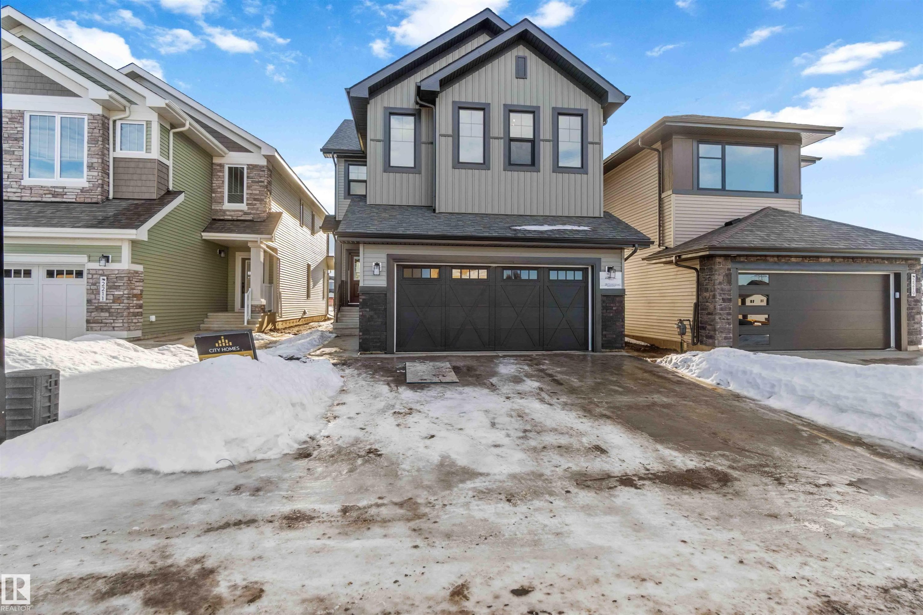 Craftsman house featuring an attached garage, stone siding, and a shingled roof - 2215 4 Avenue, Edmonton, AB - Outdoor With Facade