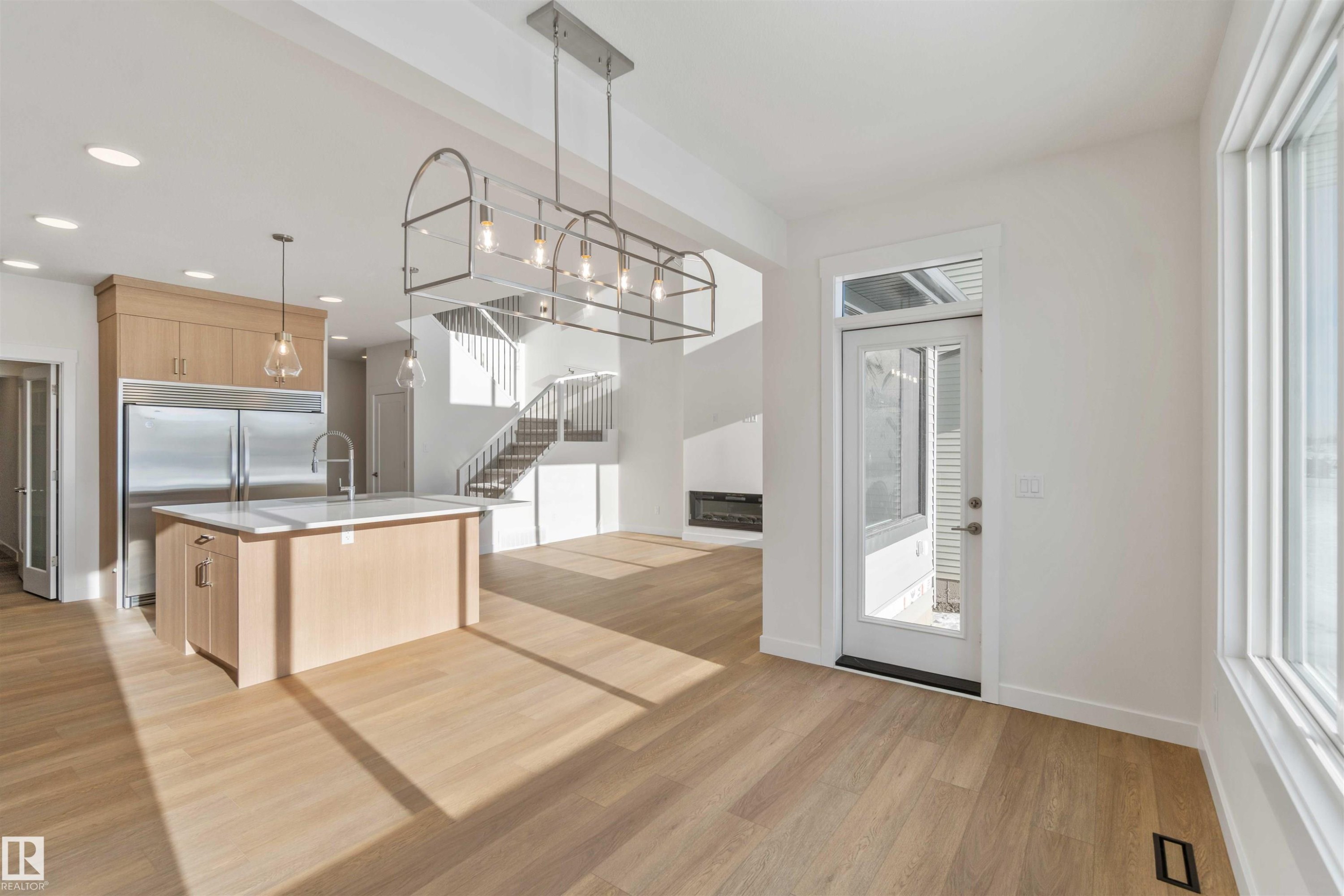 Kitchen with light brown cabinets, modern cabinets, open floor plan, a center island with sink, and recessed lighting - 2215 4 Avenue, Edmonton, AB - Indoor Photo Showing Kitchen With Upgraded Kitchen
