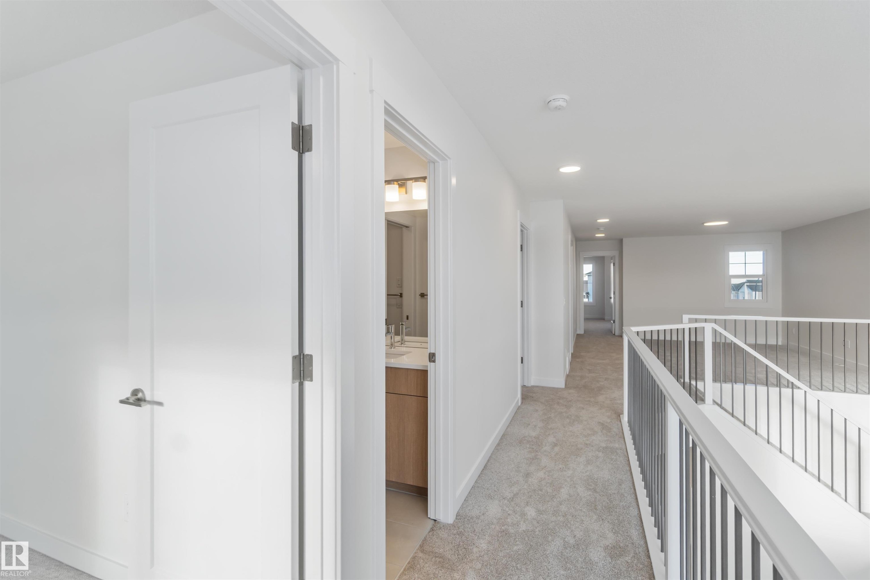 Hall featuring light carpet, recessed lighting, and an upstairs landing - 2215 4 Avenue, Edmonton, AB - Indoor Photo Showing Other Room