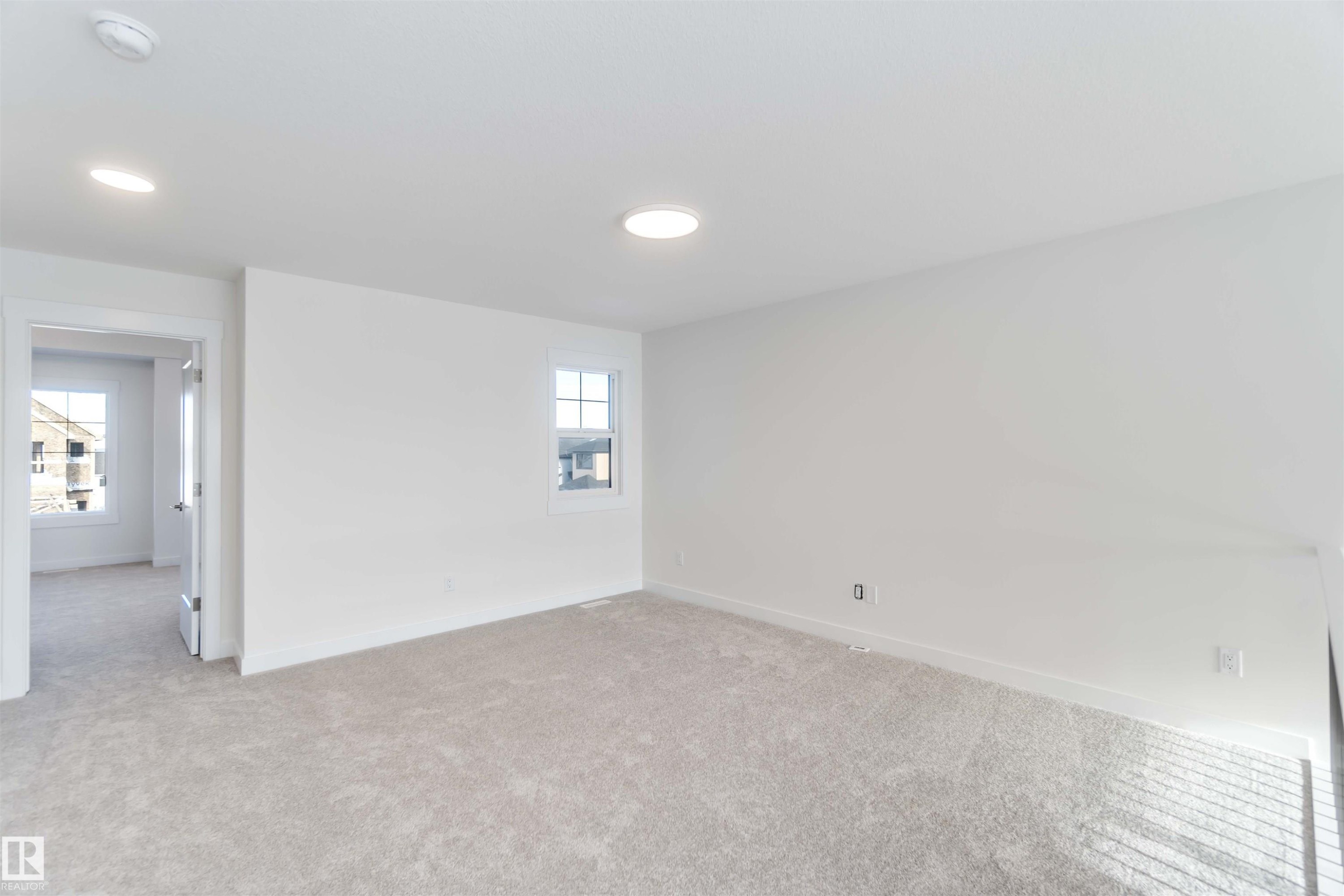Carpeted spare room with baseboards - 2215 4 Avenue, Edmonton, AB - Indoor Photo Showing Other Room