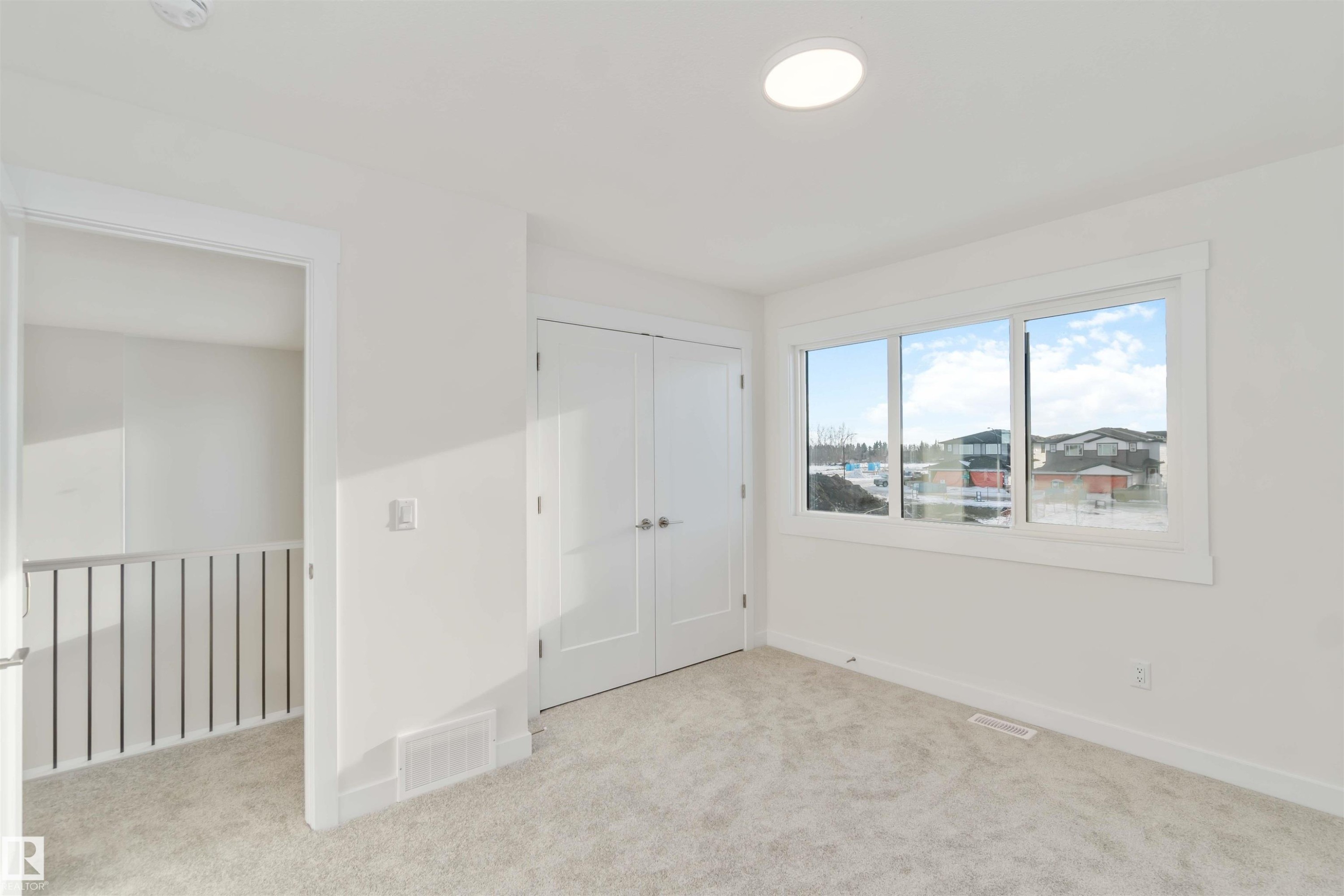 Unfurnished bedroom featuring a closet and light colored carpet - 2215 4 Avenue, Edmonton, AB - Indoor Photo Showing Other Room