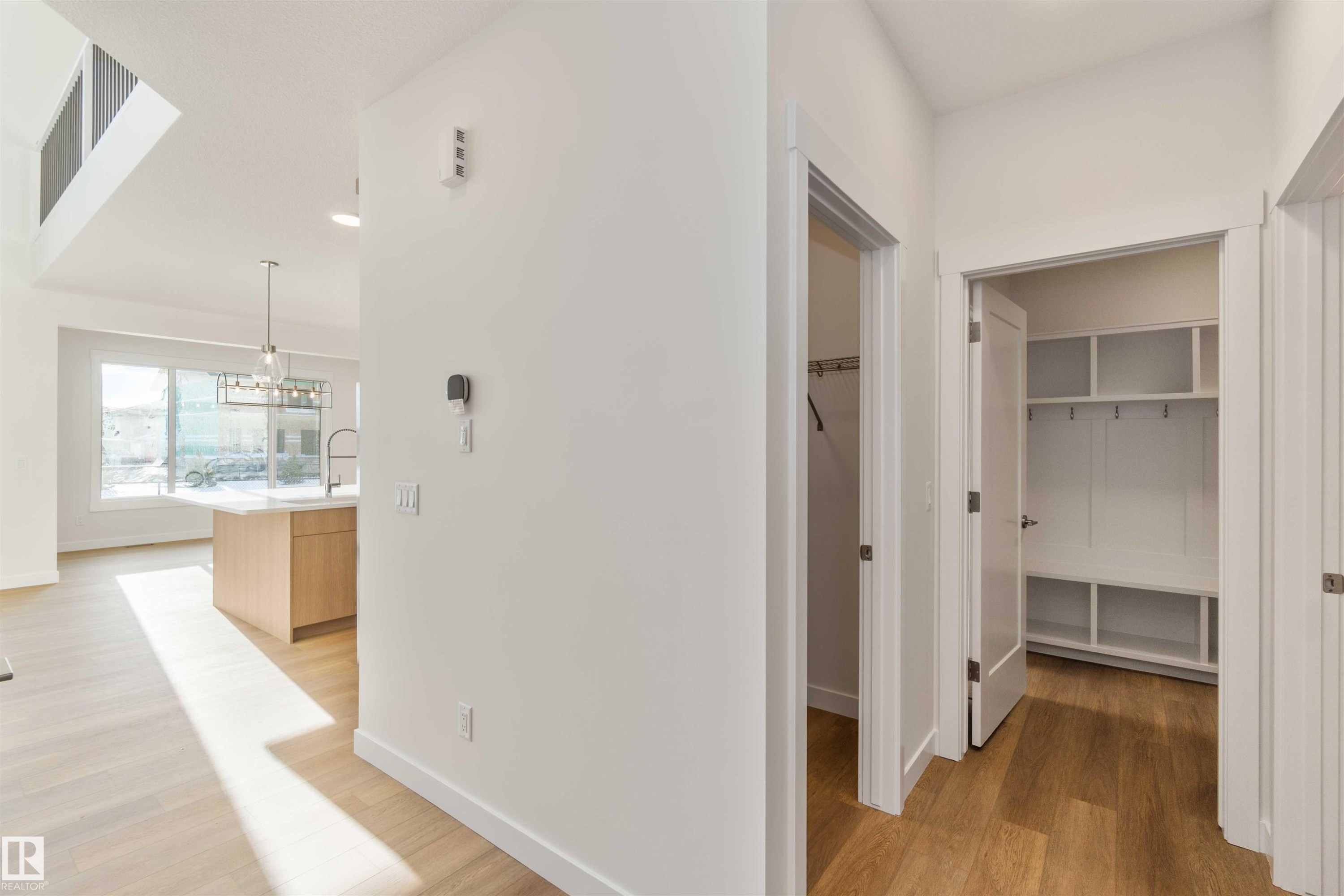 Hallway featuring light wood-style floors and a chandelier - 2215 4 Avenue, Edmonton, AB - Indoor Photo Showing Other Room