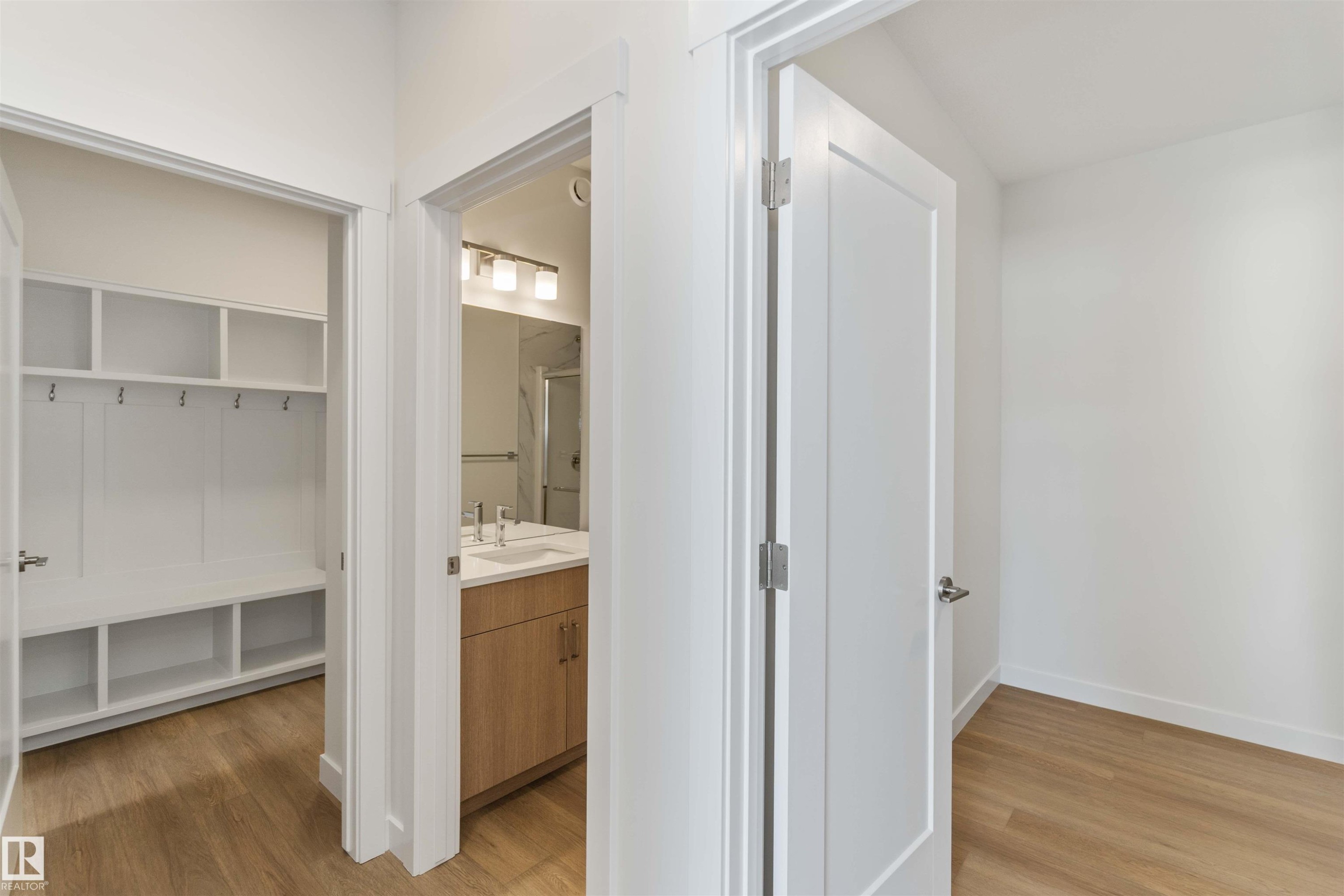 Full bath with vanity, light wood finished floors, and a walk in closet - 2215 4 Avenue, Edmonton, AB - Indoor Photo Showing Other Room