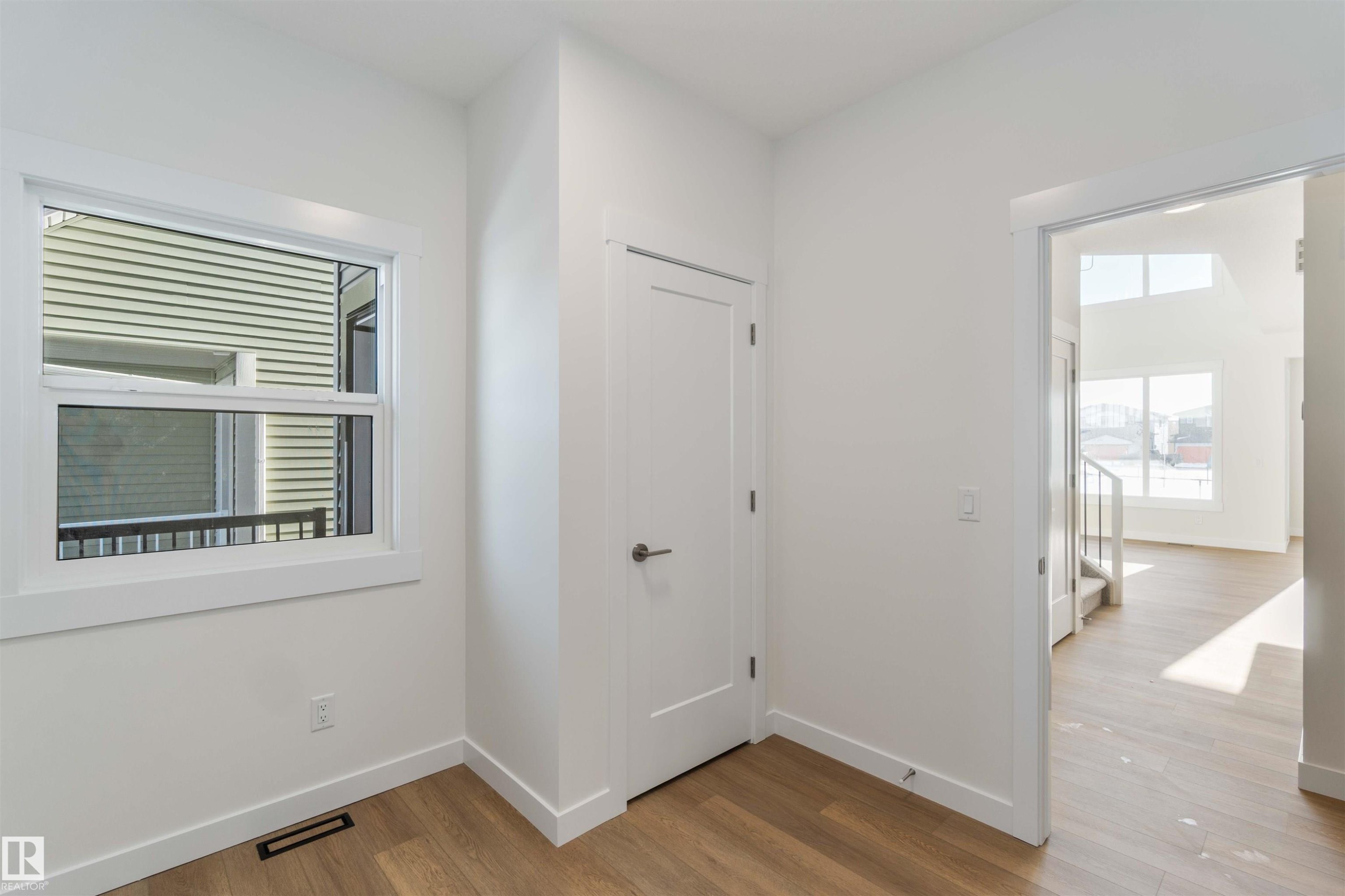 Hall with light wood-style floors and baseboards - 2215 4 Avenue, Edmonton, AB - Indoor Photo Showing Other Room