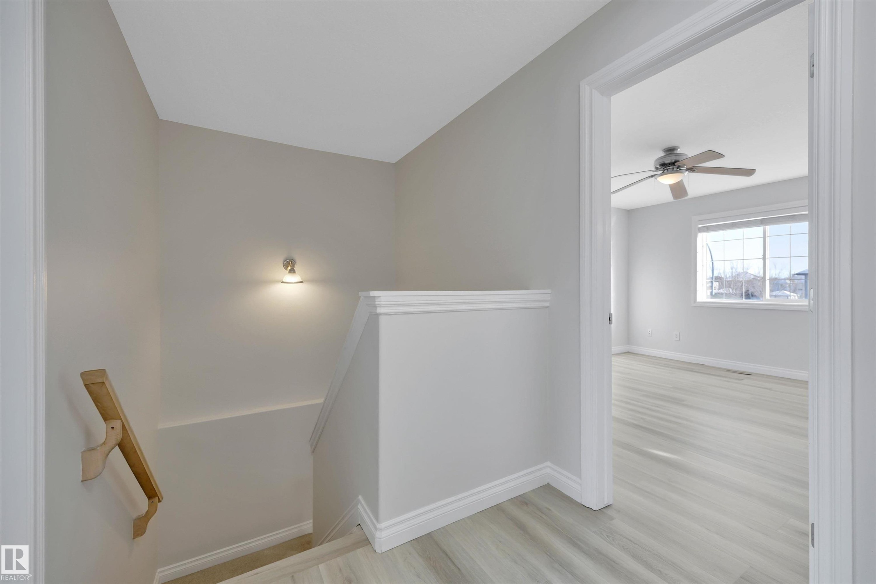 Stairs featuring wood finished floors and a ceiling fan - 457 Aster Close, Leduc, AB - Indoor Photo Showing Other Room