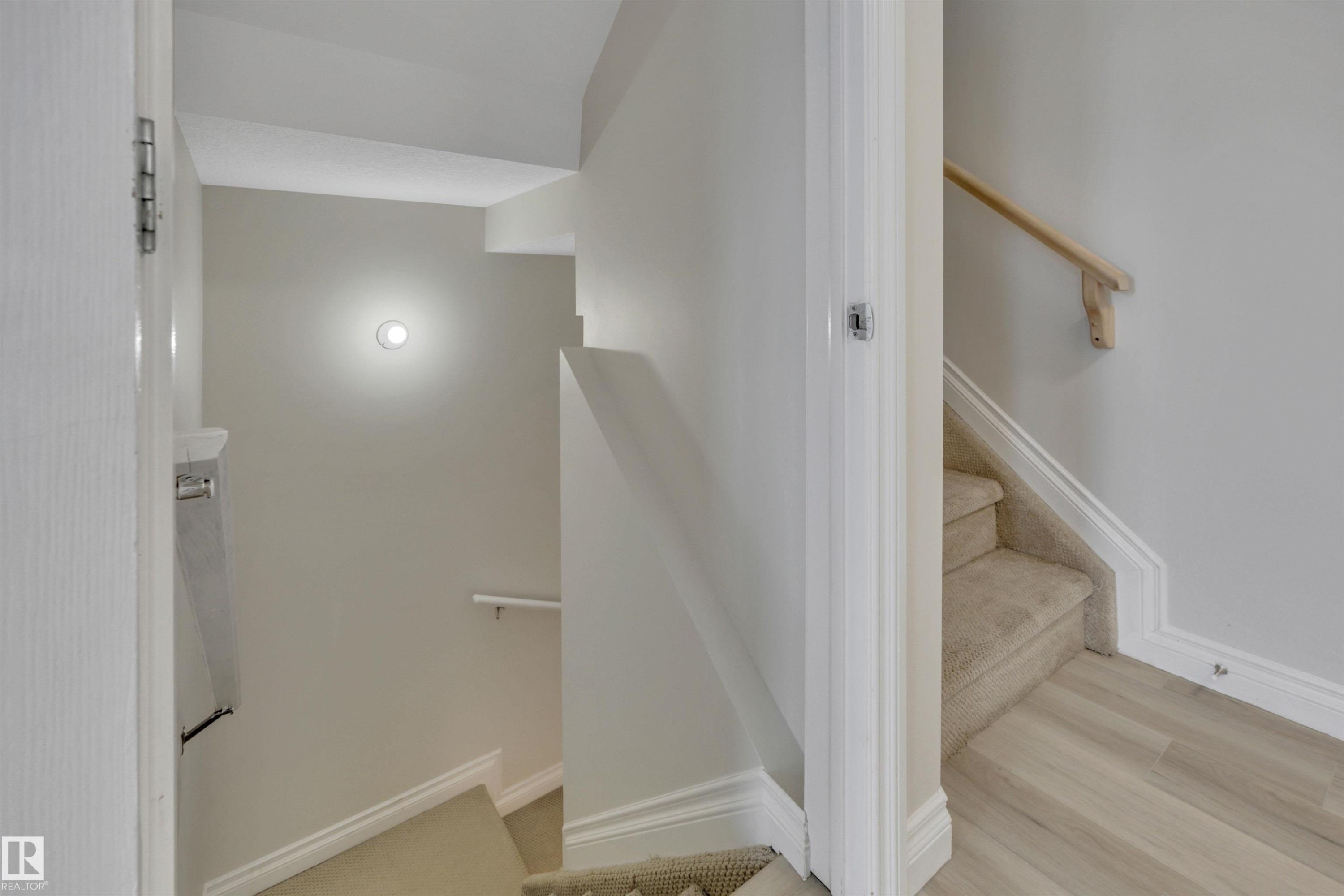 Stairway featuring baseboards and wood finished floors - 457 Aster Close, Leduc, AB - Indoor