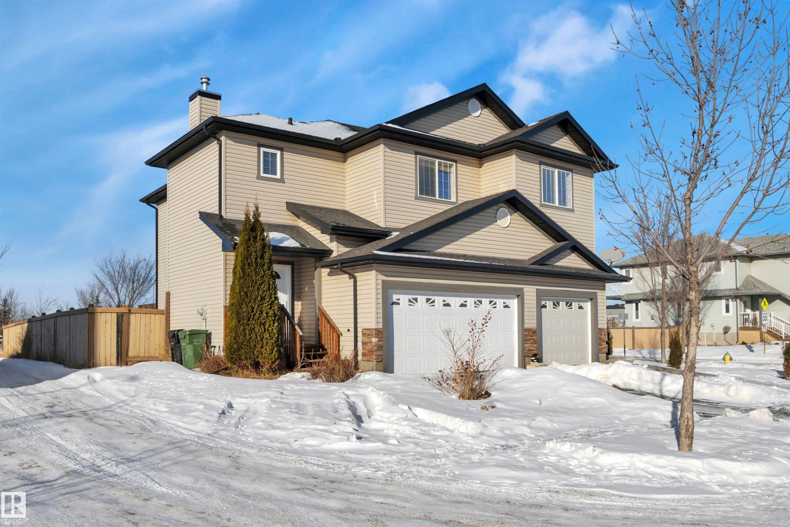 Traditional home with a chimney and a garage - 457 Aster Close, Leduc, AB - Outdoor With Facade