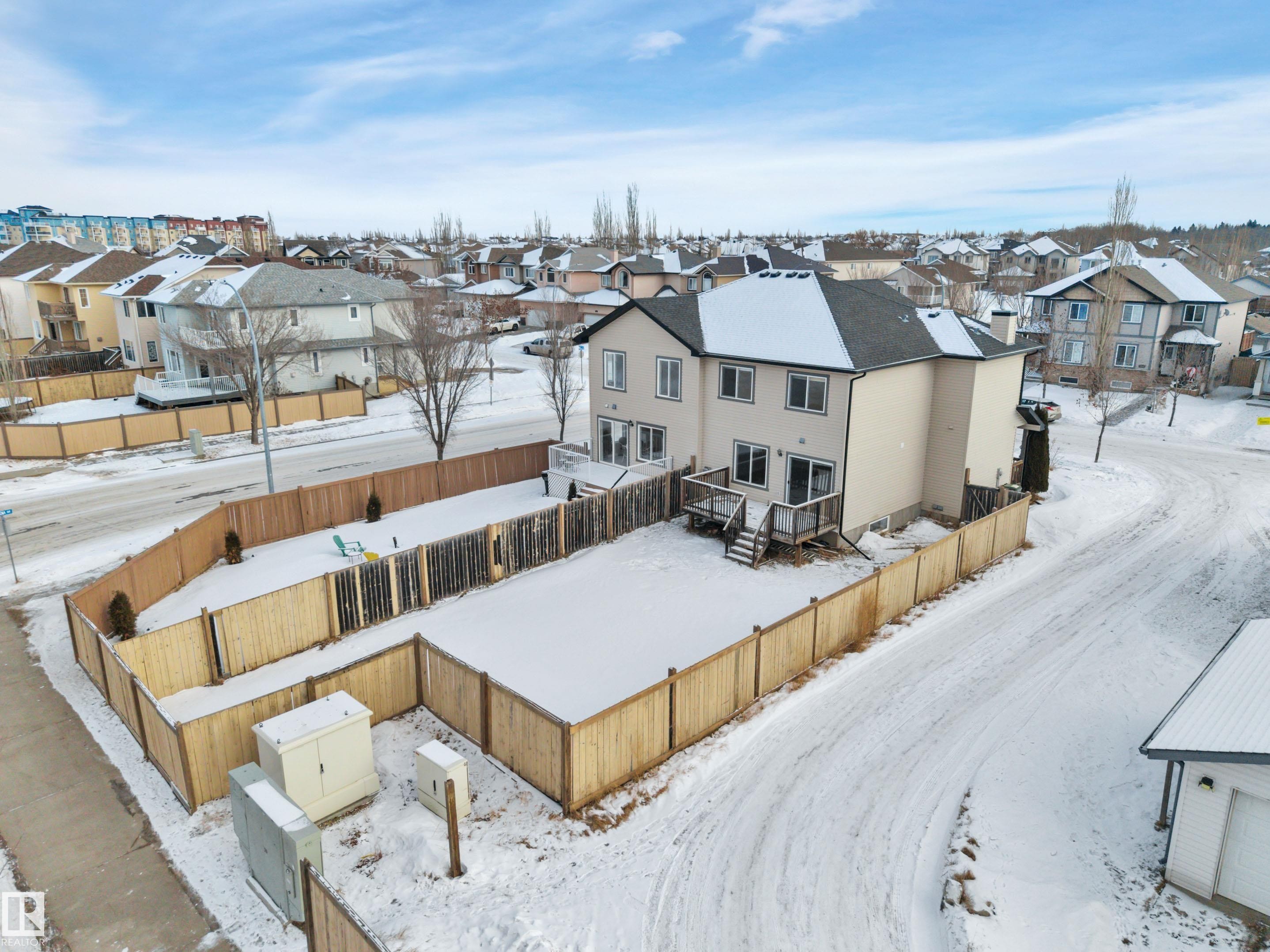 Snowy aerial view featuring a residential view - 457 Aster Close, Leduc, AB - Outdoor