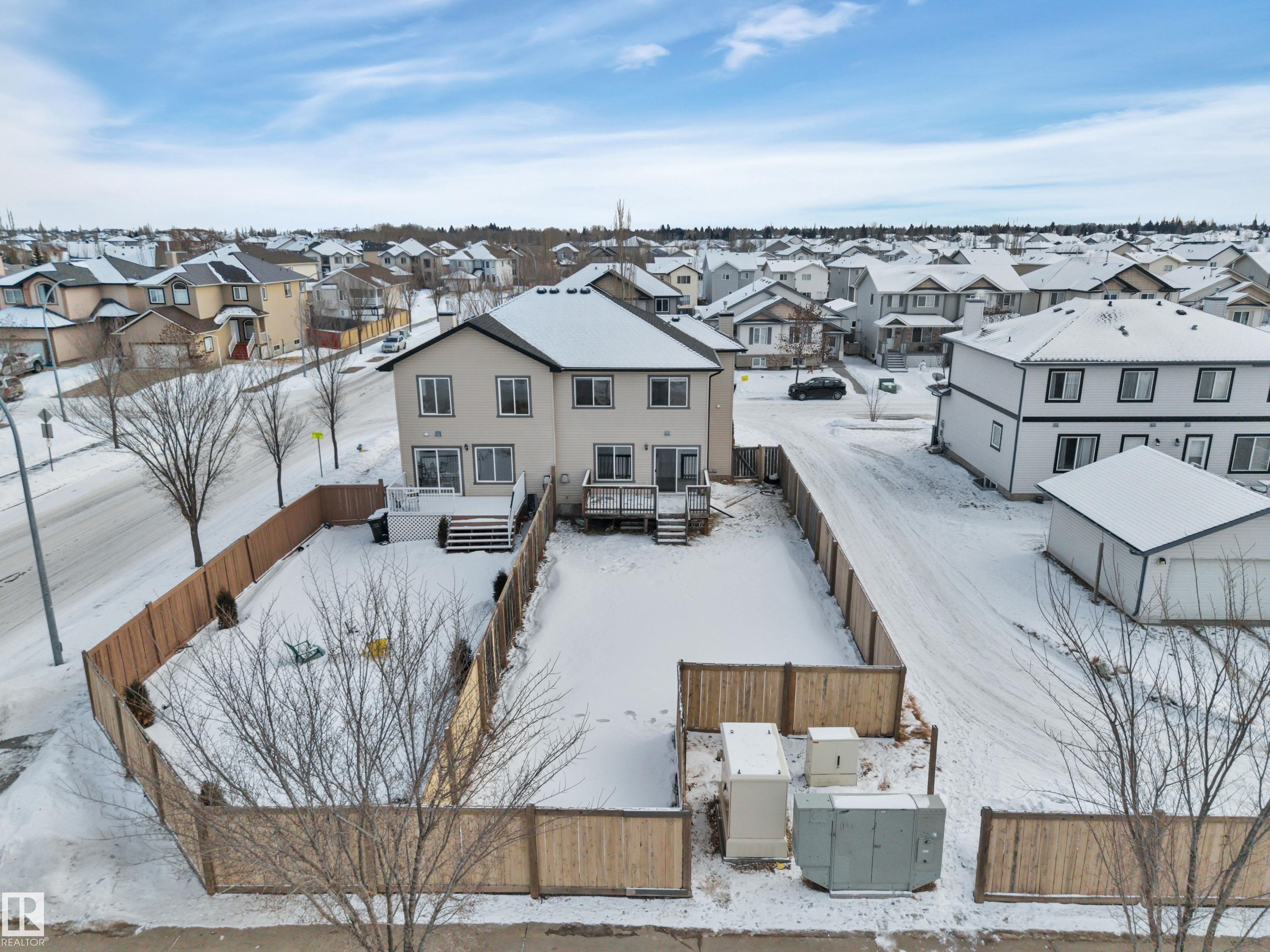 Snowy aerial view with a residential view - 457 Aster Close, Leduc, AB - Outdoor