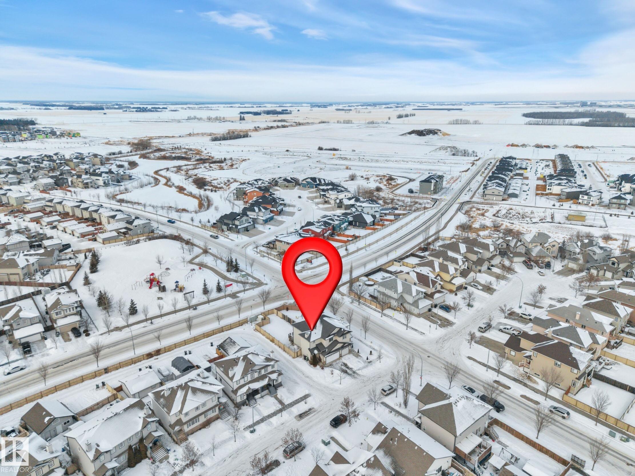 Snowy aerial view featuring a residential view - 457 Aster Close, Leduc, AB - Outdoor With View