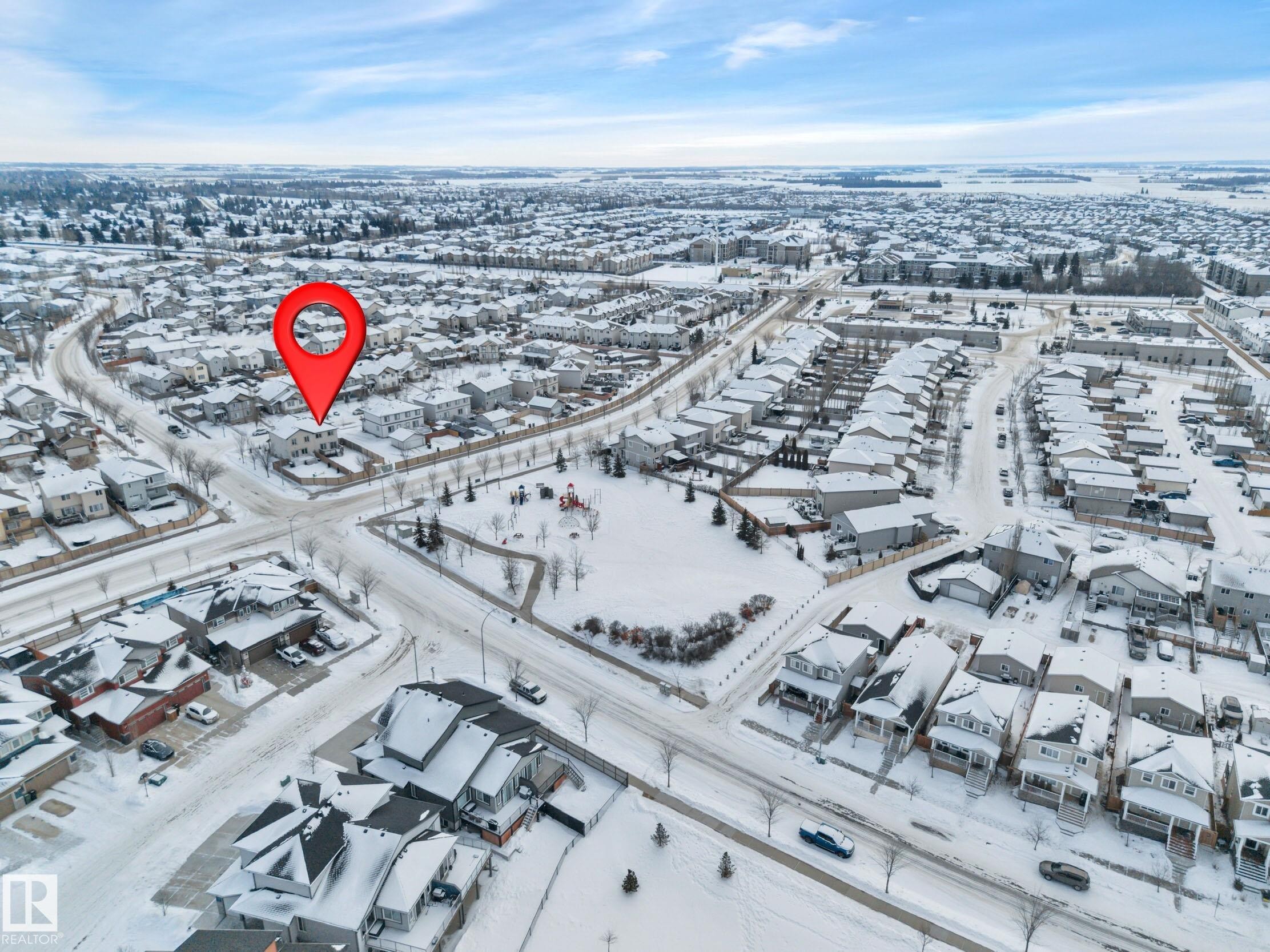 Snowy aerial view featuring a residential view - 457 Aster Close, Leduc, AB - Outdoor With View