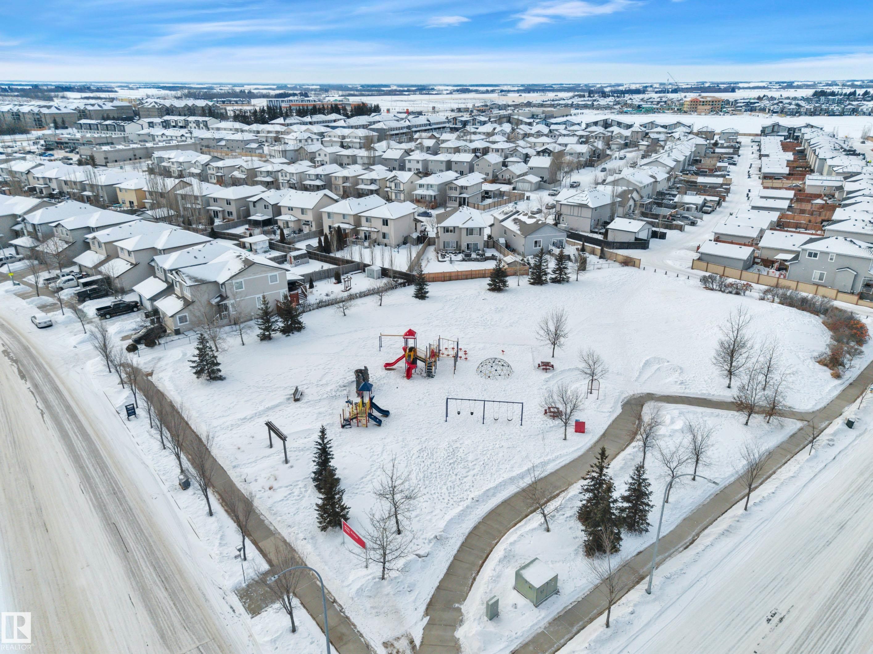 Snowy aerial view featuring a residential view - 457 Aster Close, Leduc, AB - Outdoor With View