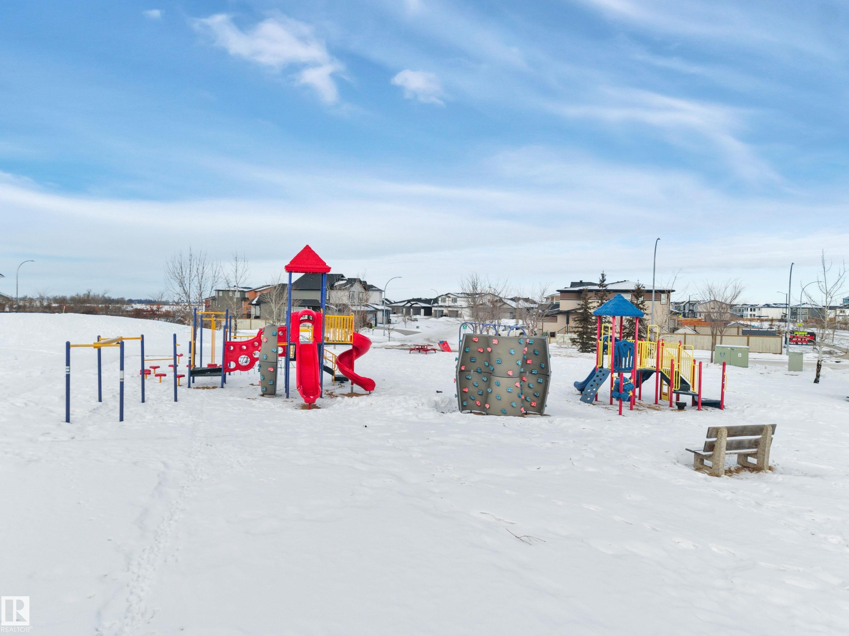 Snow covered playground featuring a playground - 457 Aster Close, Leduc, AB - Outdoor With View