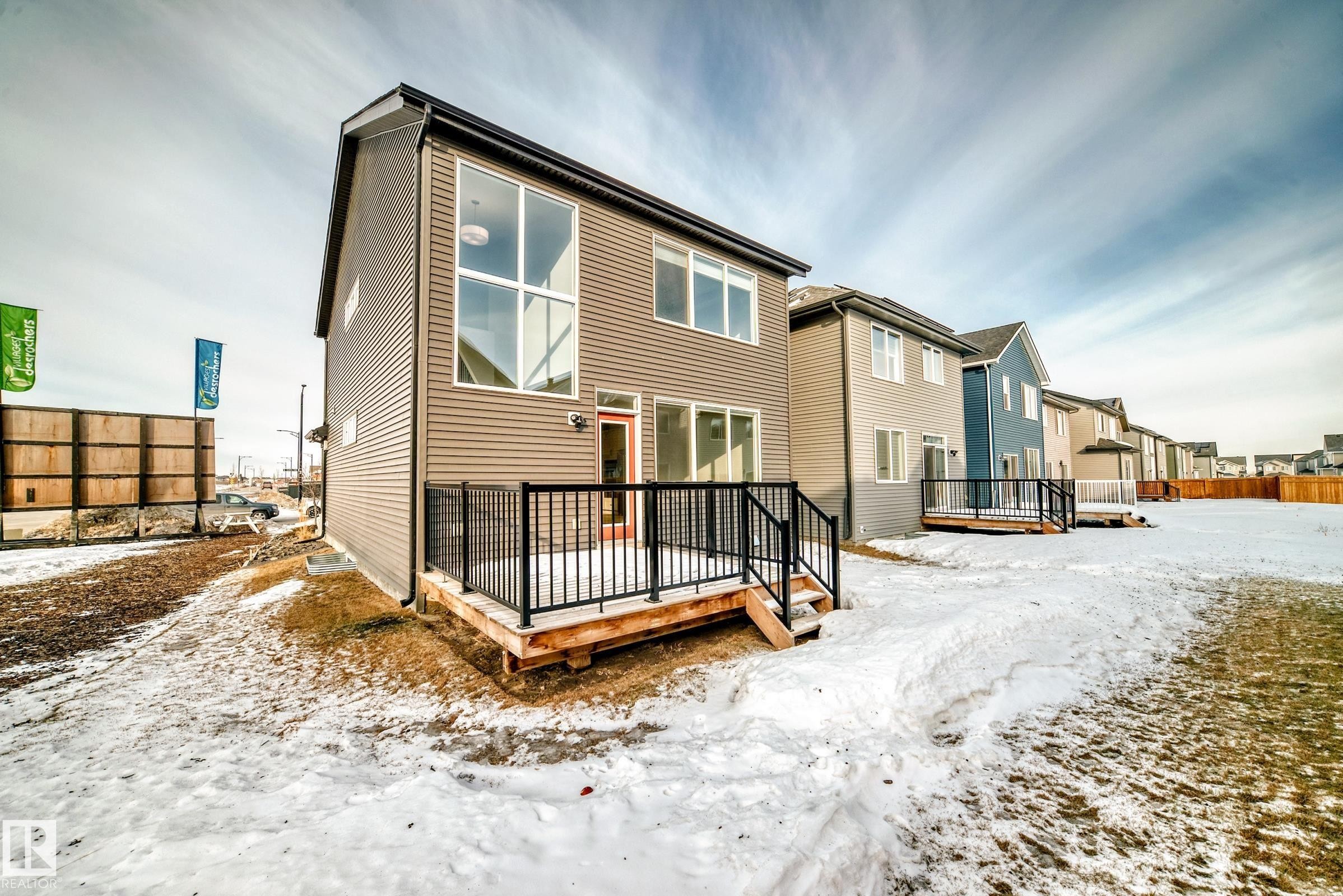Snow covered house featuring a deck - 3249 Dixon Way, Edmonton, AB - Outdoor With Deck Patio Veranda With Exterior