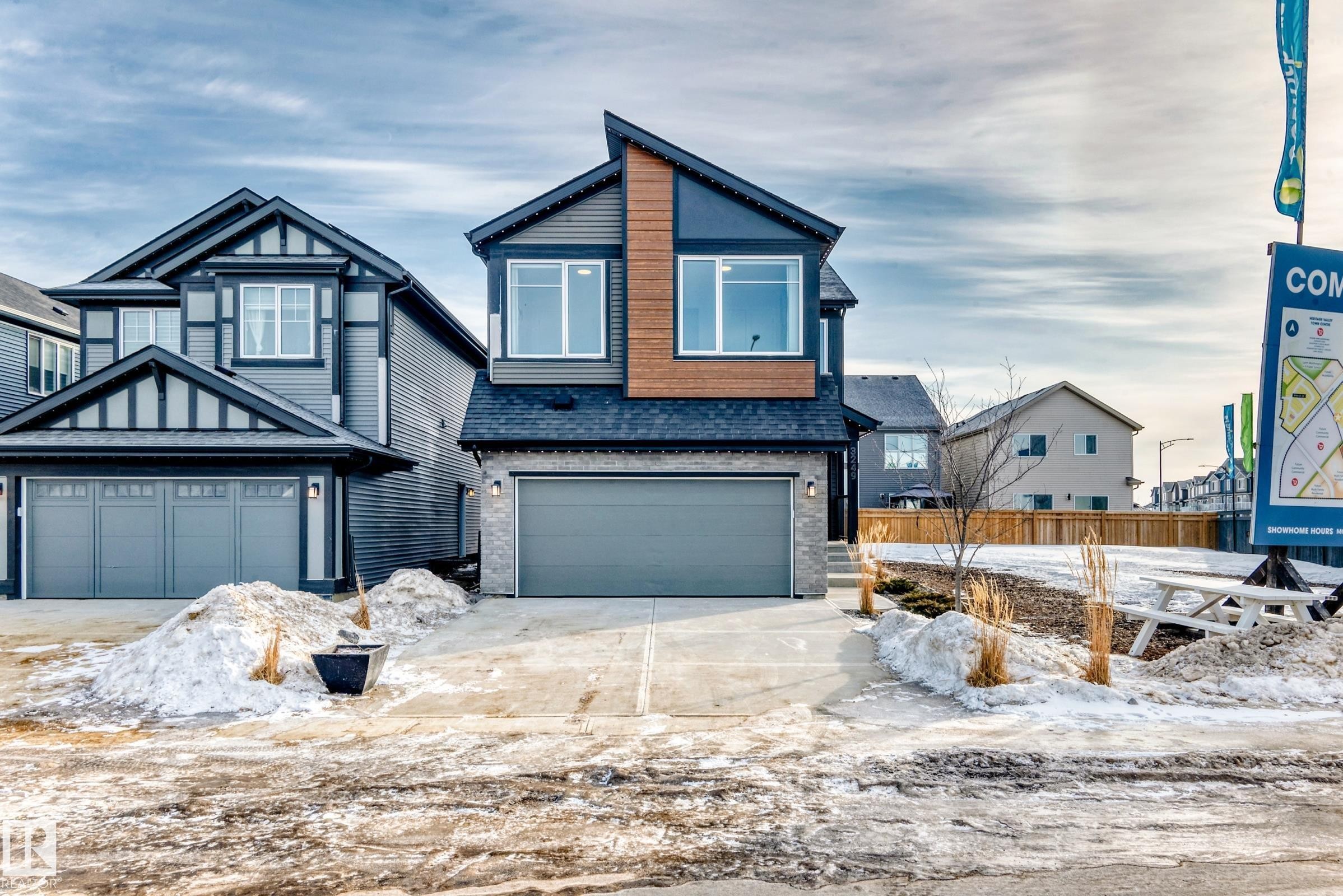 View of front of house with a shingled roof, brick siding, a garage, and driveway - 3249 Dixon Way, Edmonton, AB - Outdoor With Facade