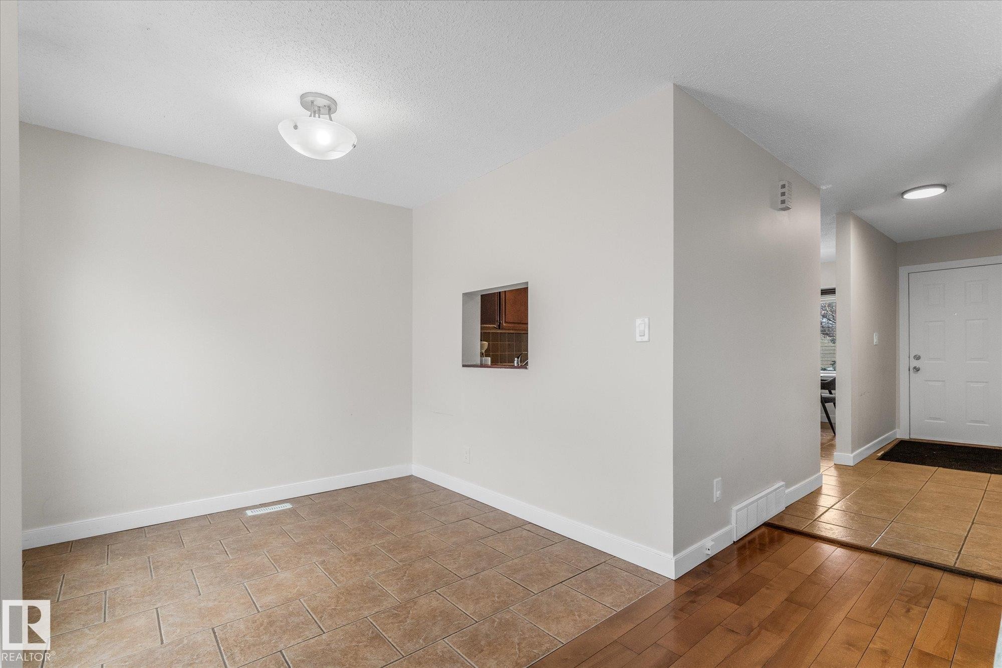 Entryway featuring light tile patterned flooring and a textured ceiling - 289 Grandin Village, St. Albert, AB - Indoor Photo Showing Other Room