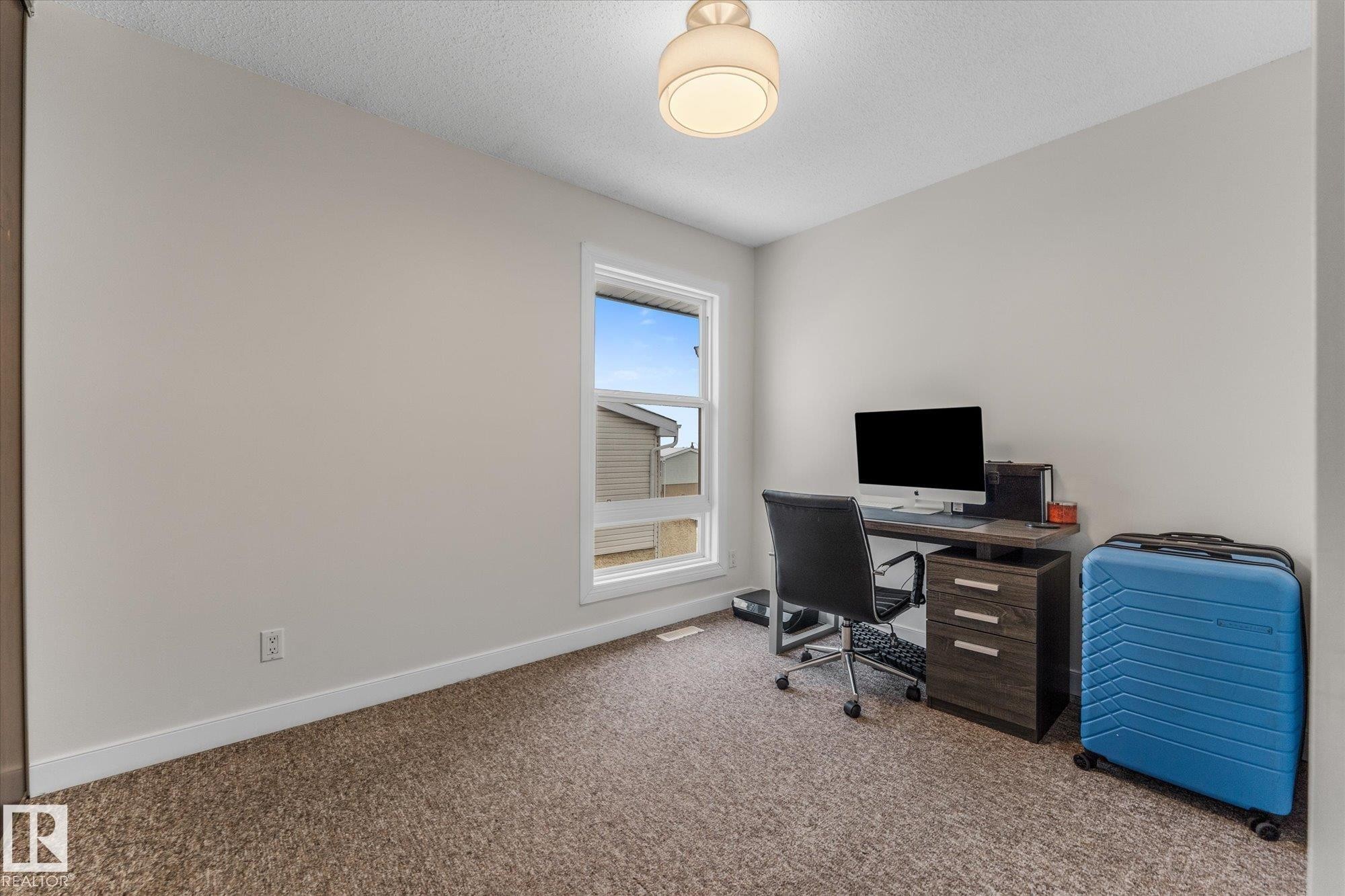 Carpeted office featuring baseboards and a textured ceiling - 289 Grandin Village, St. Albert, AB - Indoor Photo Showing Office