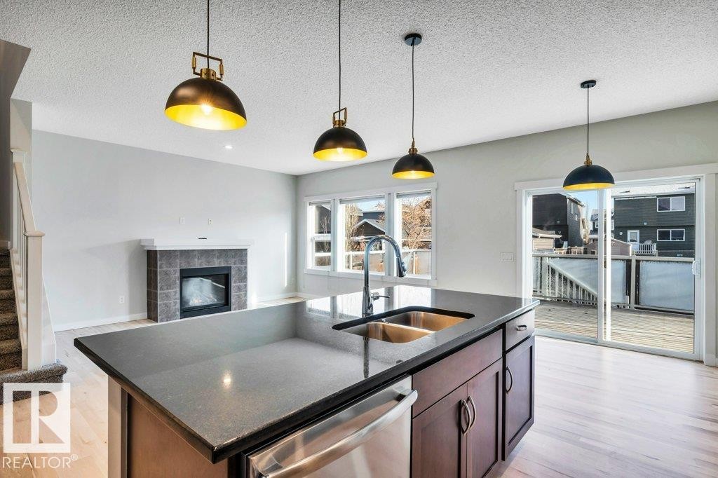 237 Sheppard Circle, Leduc, AB - Indoor Photo Showing Kitchen With Fireplace With Double Sink