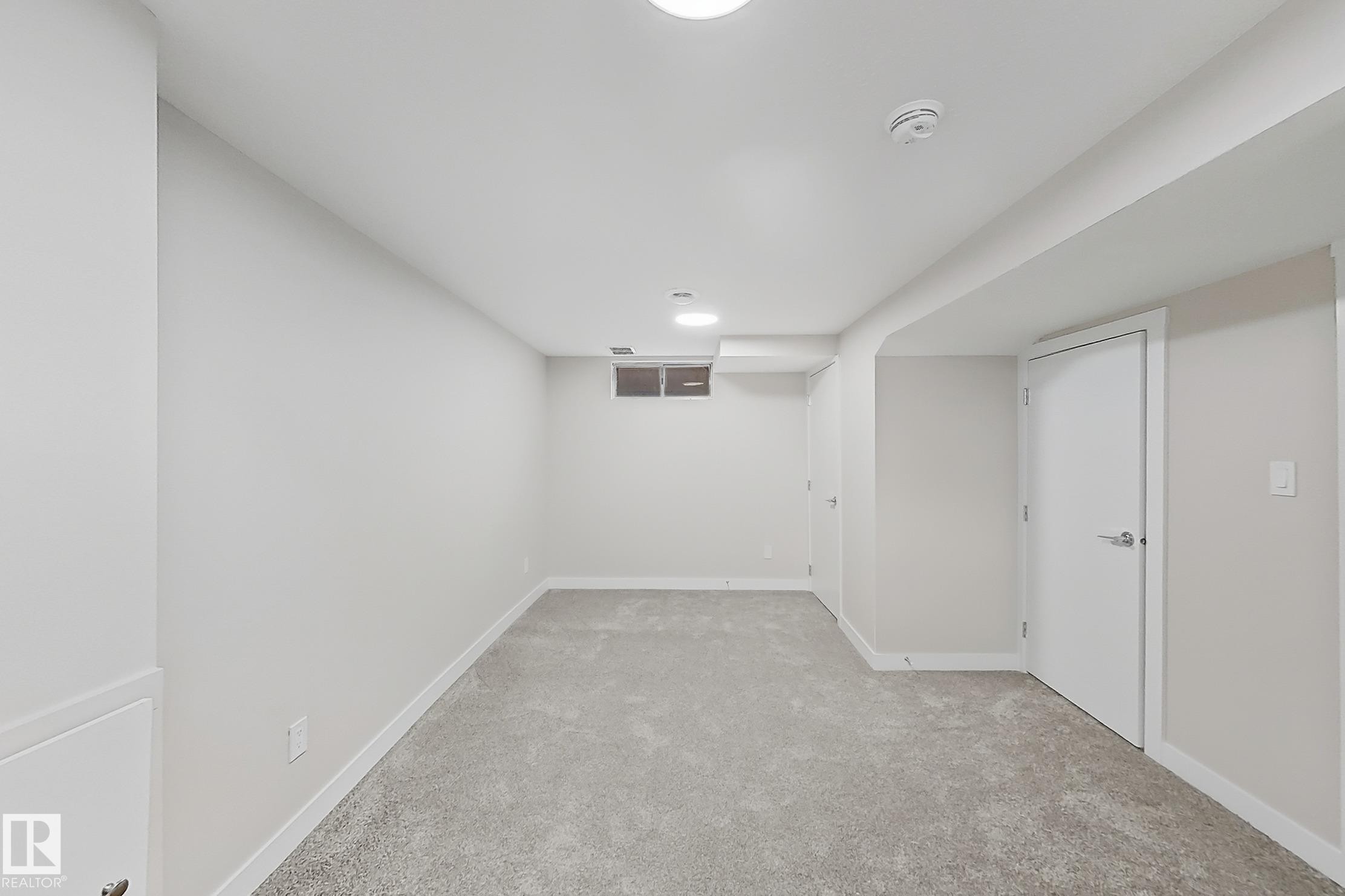 Finished below grade area featuring light carpet and baseboards - 24 3812 20 Avenue, Edmonton, AB - Indoor Photo Showing Other Room