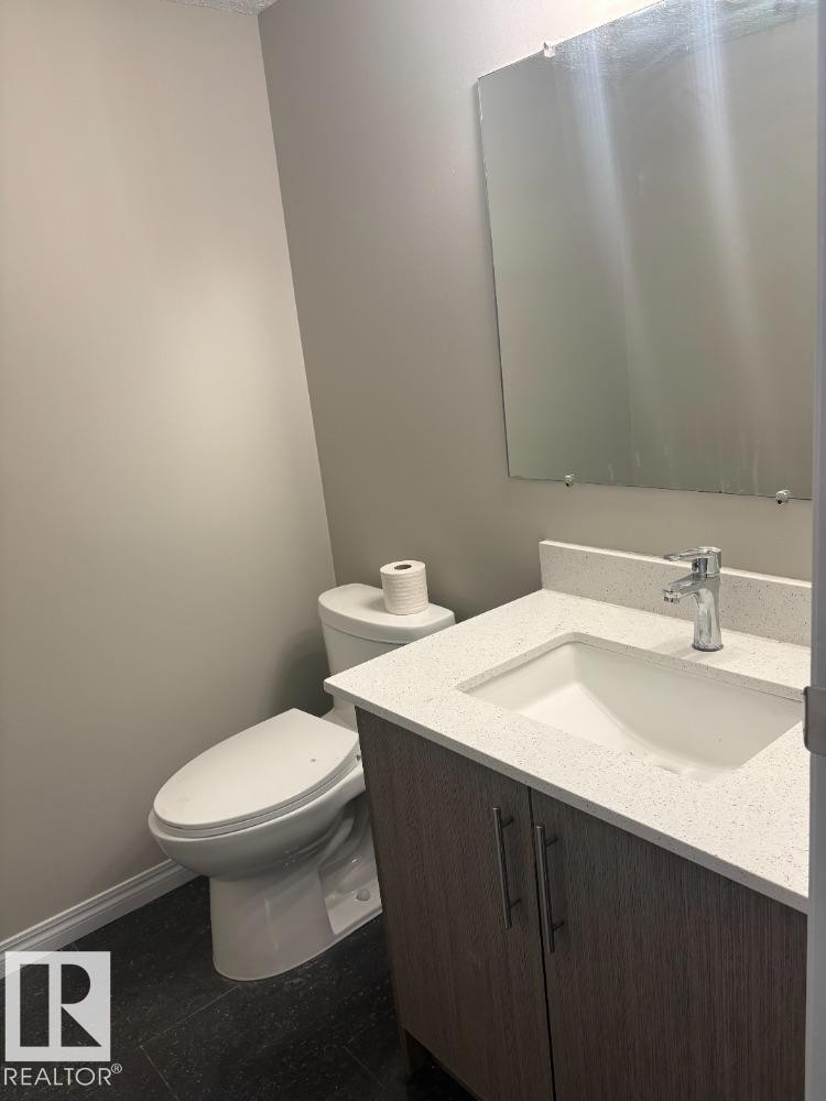 Half bathroom with vanity and toilet - 24 3812 20 Avenue, Edmonton, AB - Indoor Photo Showing Bathroom