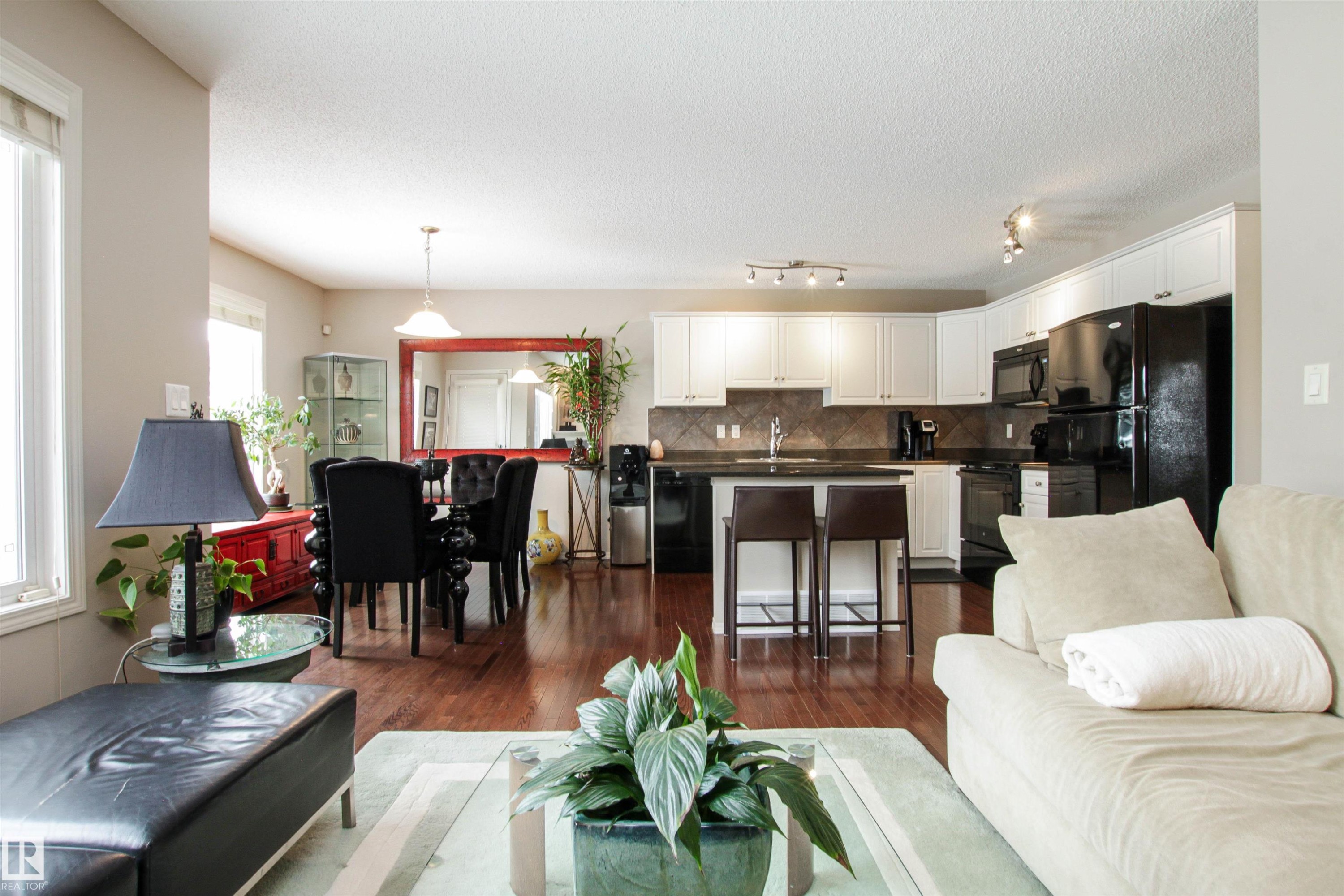Living room featuring dark wood-style floors and a textured ceiling - 2315 Lemieux Place, Edmonton, AB - Indoor Photo Showing Living Room
