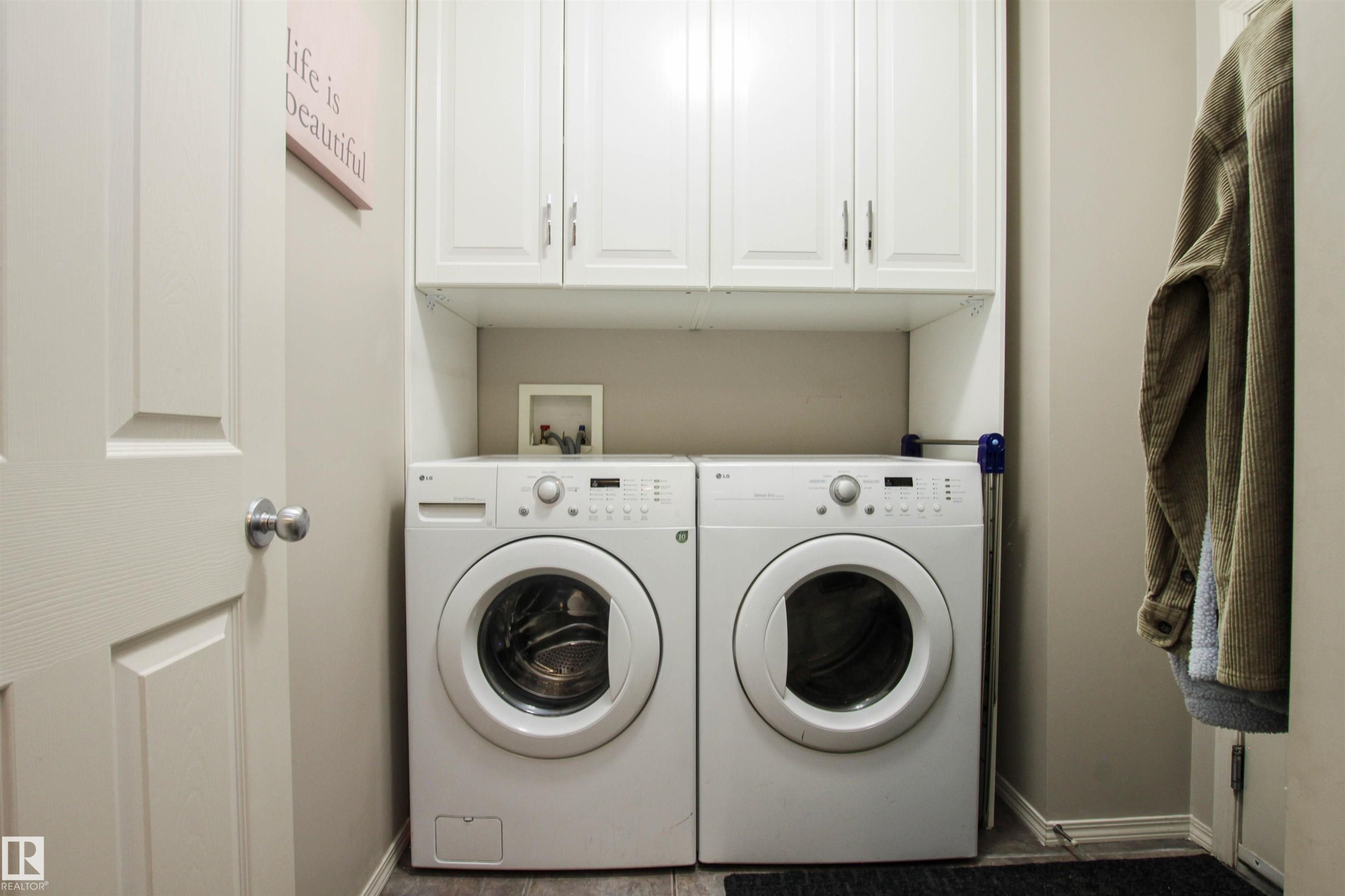 Laundry area with cabinet space and separate washer and dryer - 2315 Lemieux Place, Edmonton, AB - Indoor Photo Showing Laundry Room