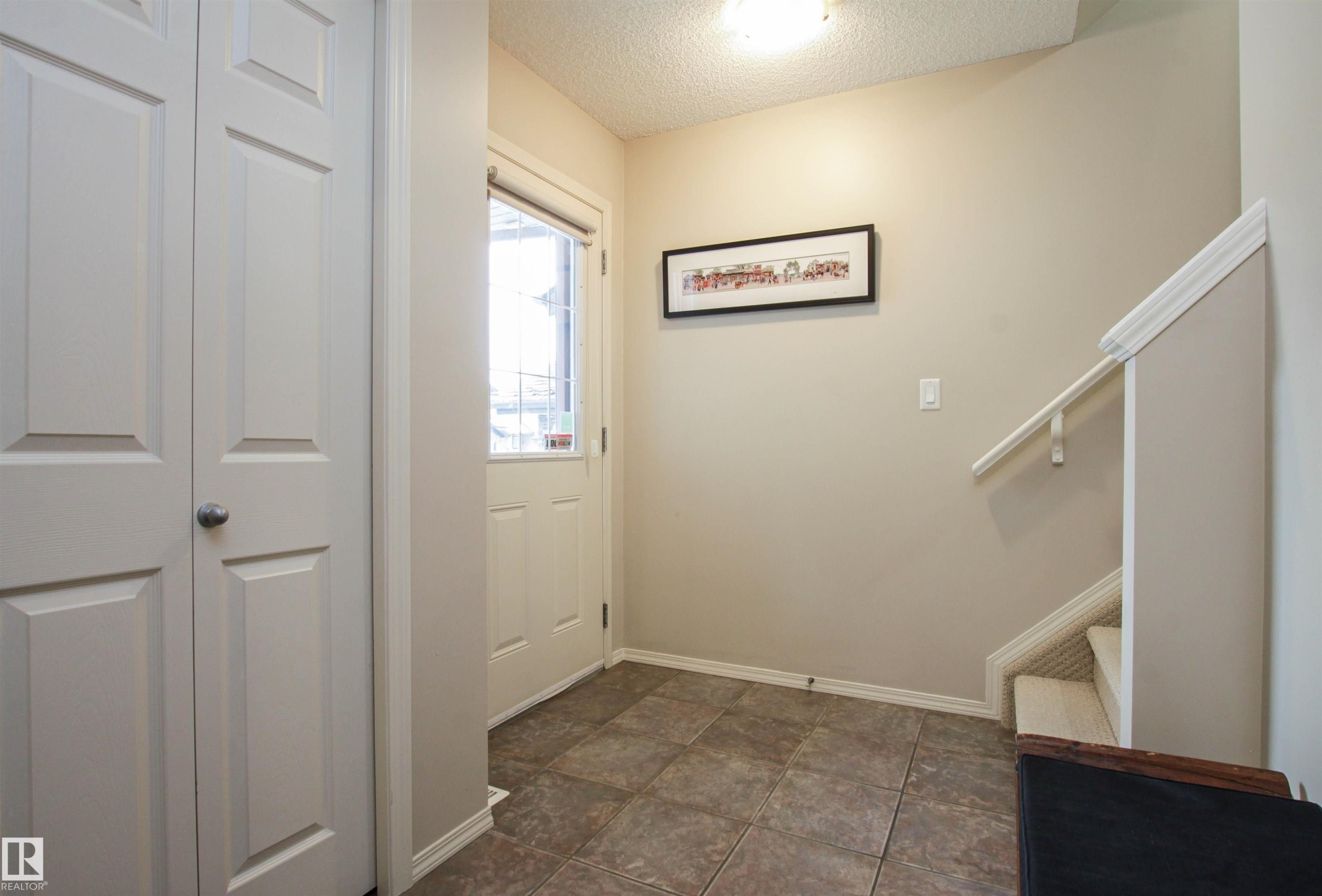 Entryway featuring a textured ceiling and stairway - 2315 Lemieux Place, Edmonton, AB - Indoor Photo Showing Other Room