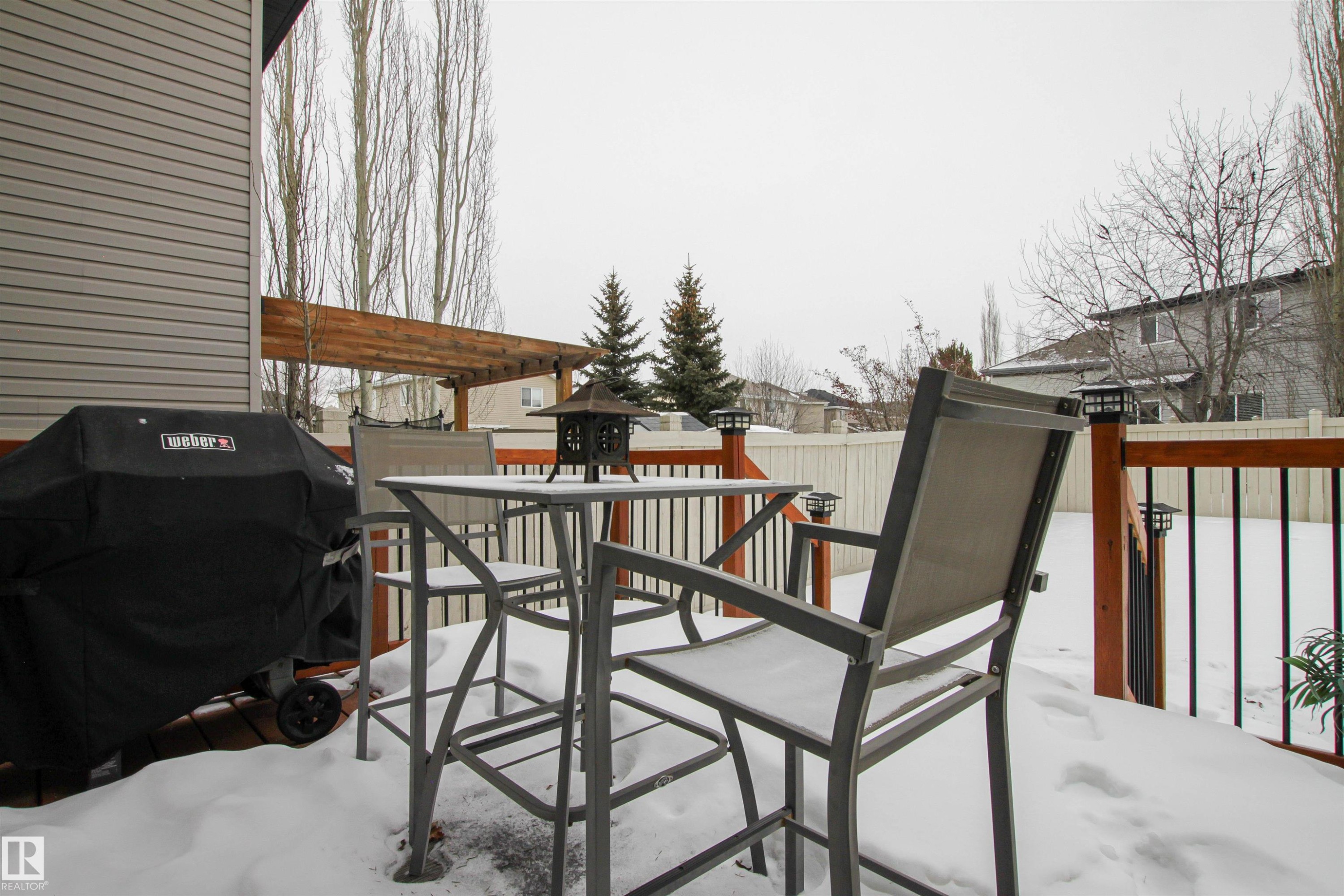 Snow covered deck featuring a grill and outdoor dining space - 2315 Lemieux Place, Edmonton, AB - Outdoor With Deck Patio Veranda With Exterior