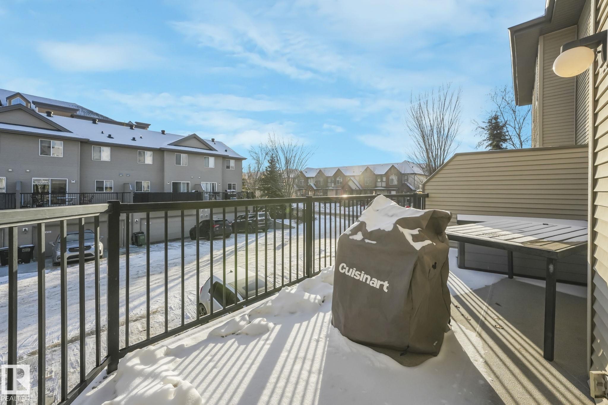 View of patio featuring area for grilling, a residential view, and a wooden deck - 23 4755 Terwillegar Common, Edmonton, AB - Outdoor With Balcony With Exterior