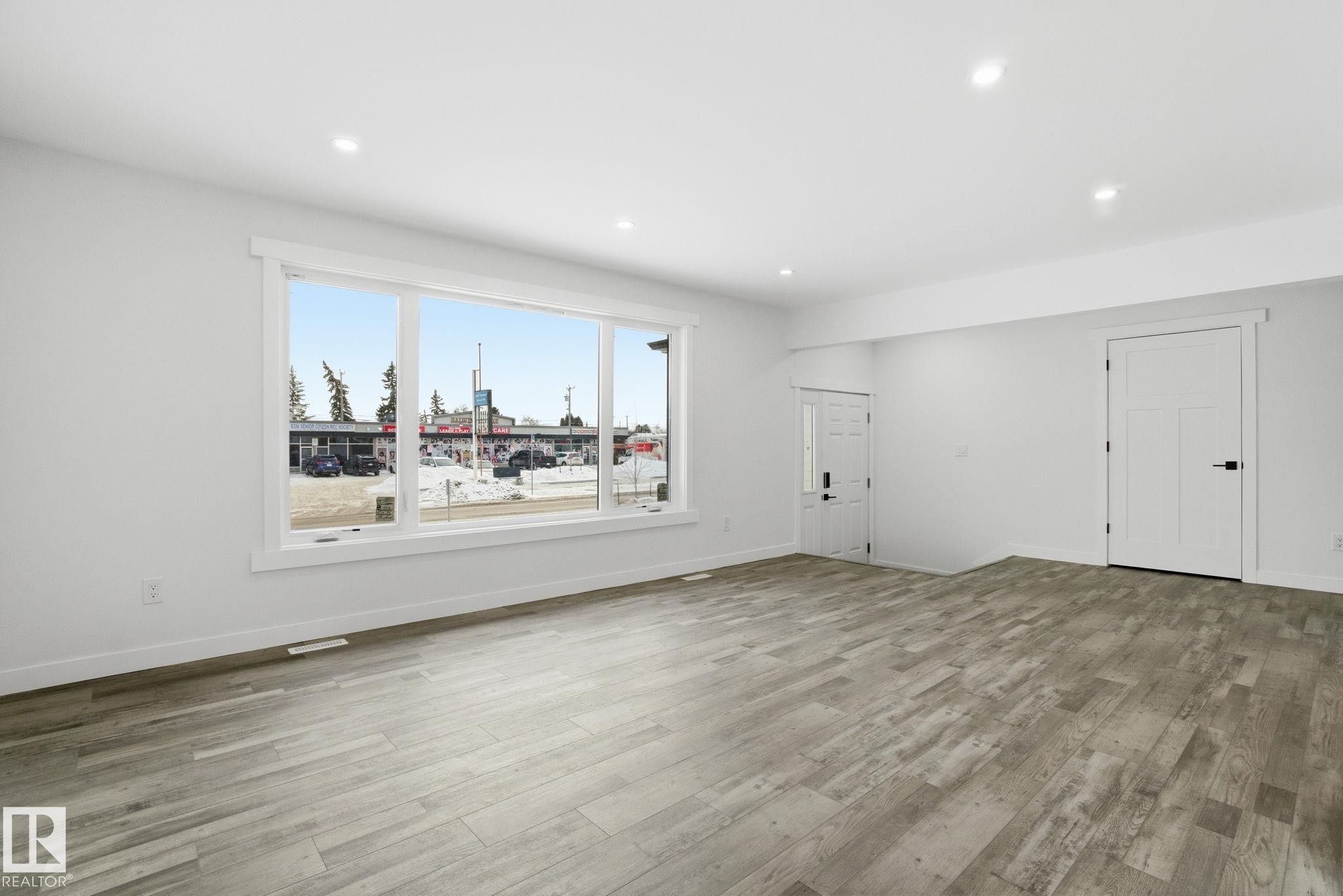 Unfurnished living room with light wood-type flooring and recessed lighting - 7112 132 Avenue, Edmonton, AB - Indoor Photo Showing Other Room