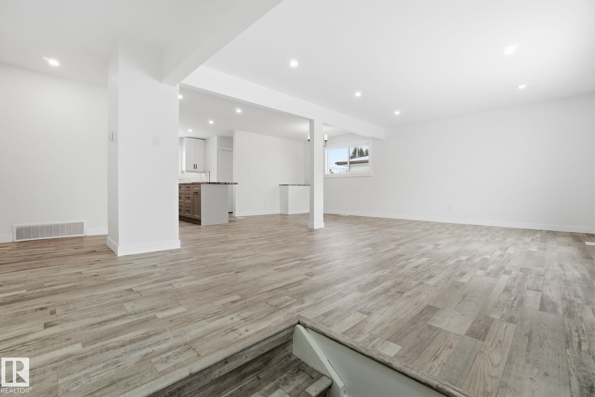 Below grade area with light wood-style flooring and recessed lighting - 7112 132 Avenue, Edmonton, AB - Indoor