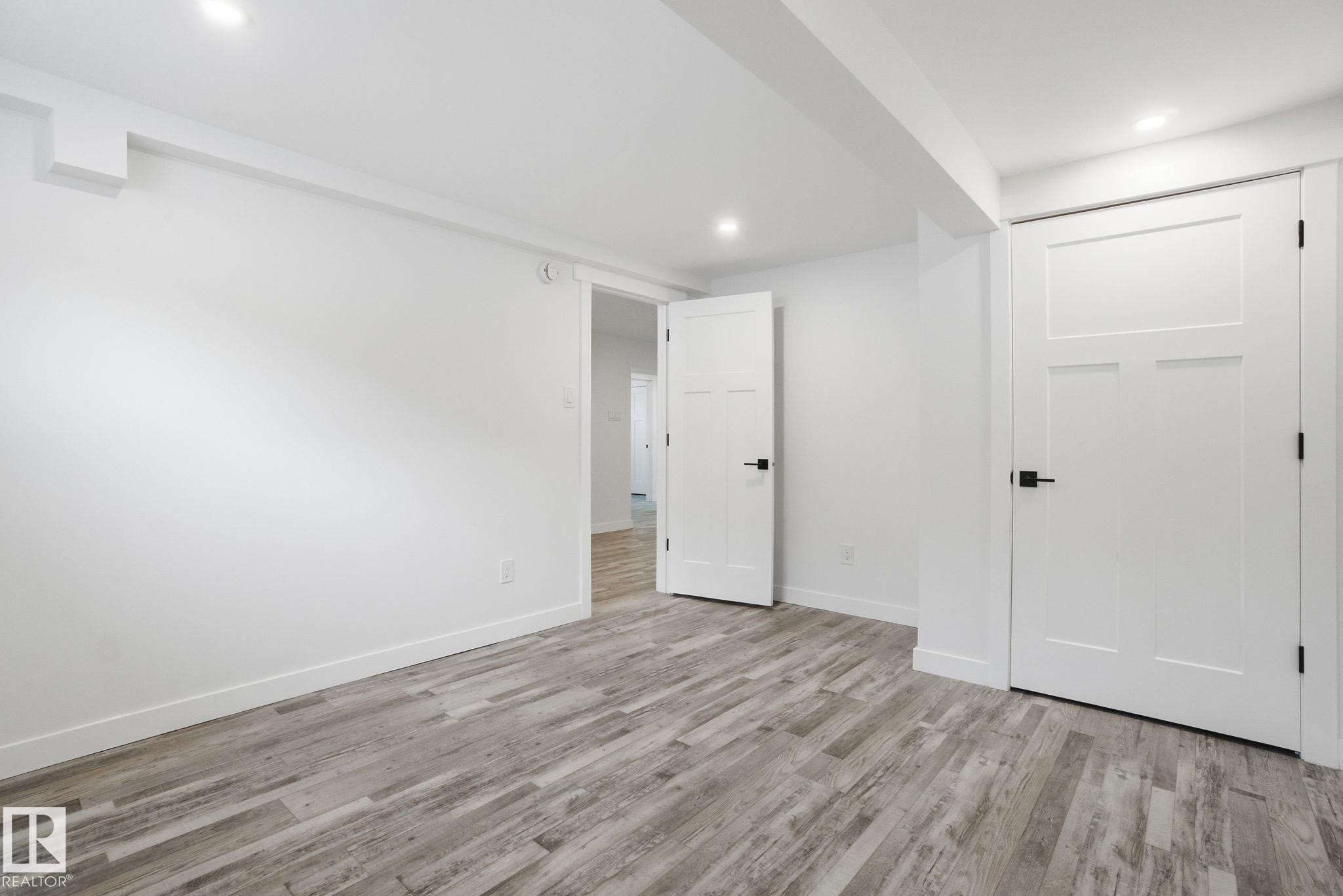 Unfurnished bedroom featuring light wood-style floors and recessed lighting - 7112 132 Avenue, Edmonton, AB - Indoor Photo Showing Other Room
