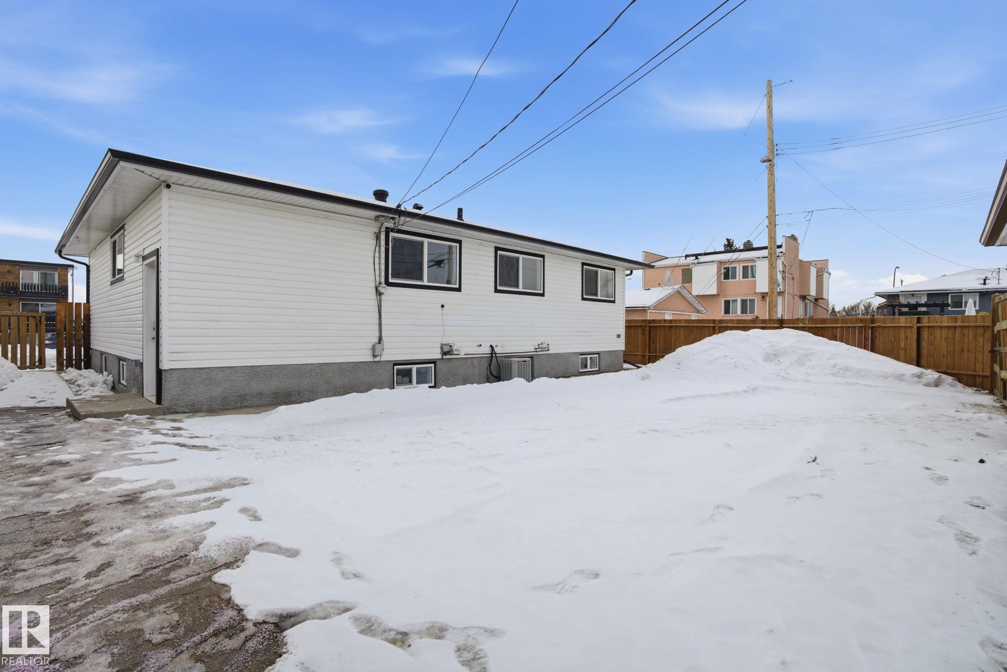 View of snow covered back of property - 7112 132 Avenue, Edmonton, AB - Outdoor With Exterior