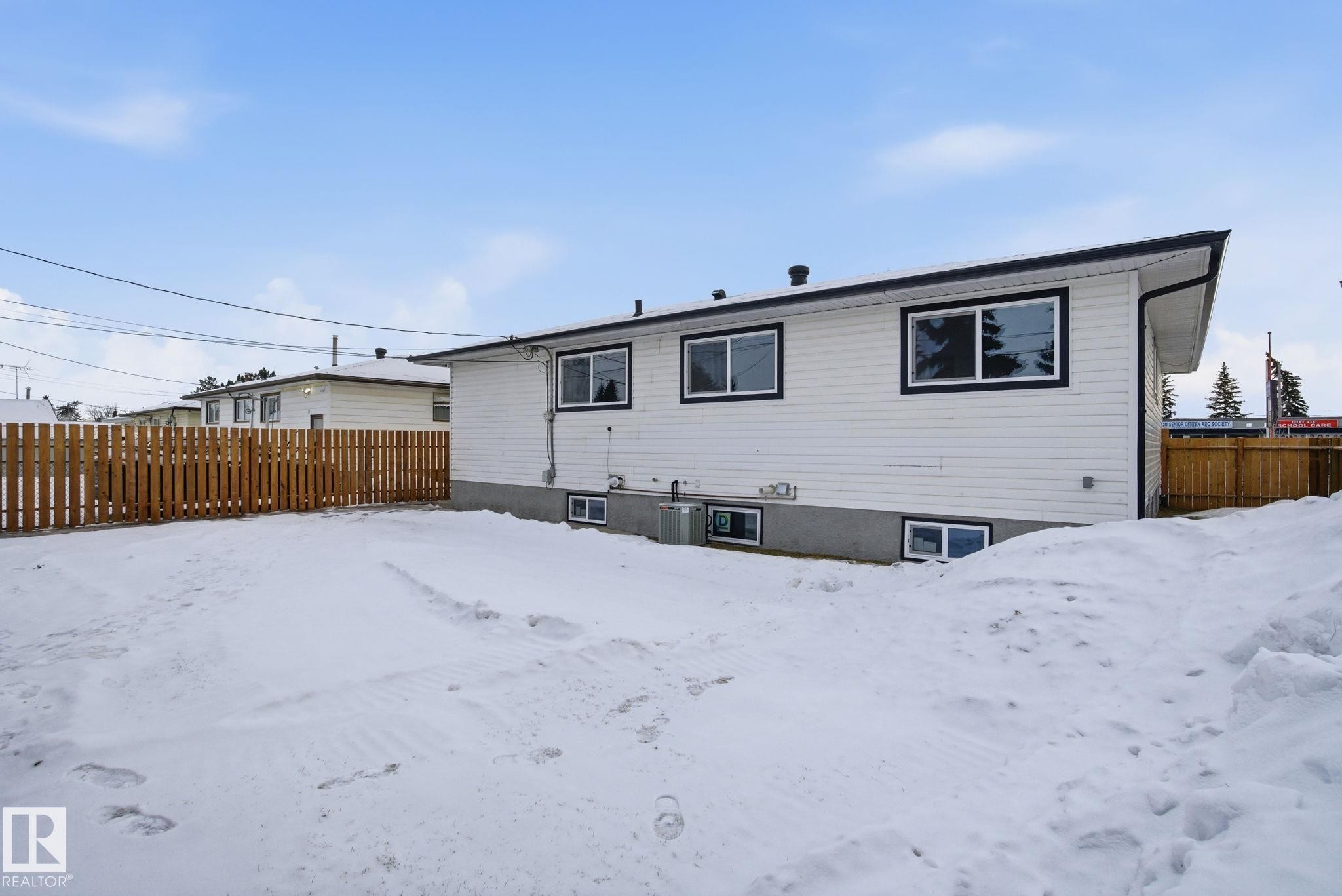View of snow covered rear of property - 7112 132 Avenue, Edmonton, AB - Outdoor With Exterior