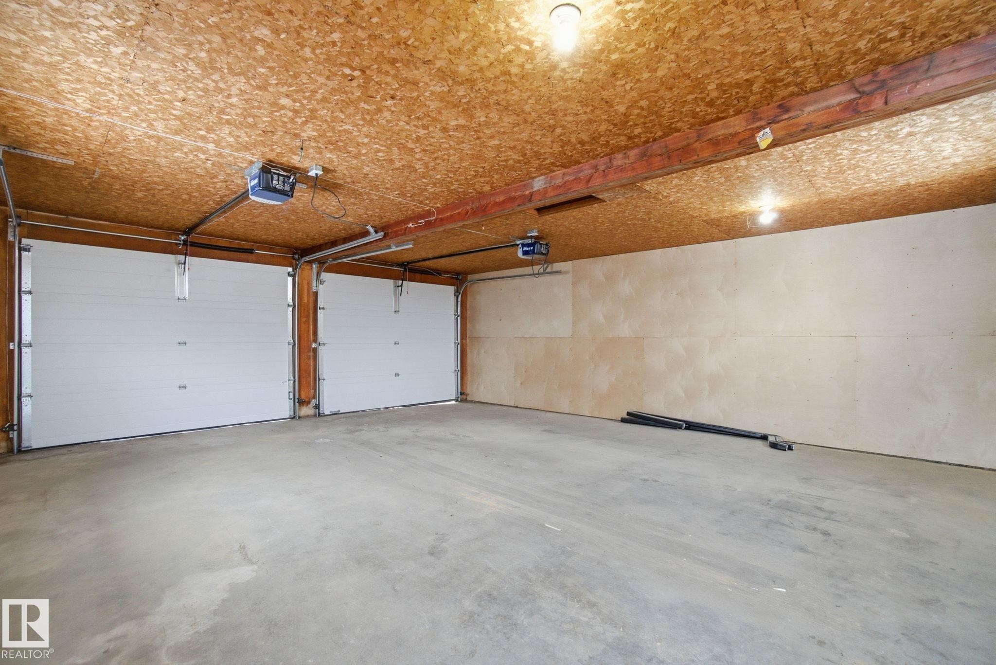 Garage with a garage door opener - 7112 132 Avenue, Edmonton, AB - Indoor Photo Showing Garage