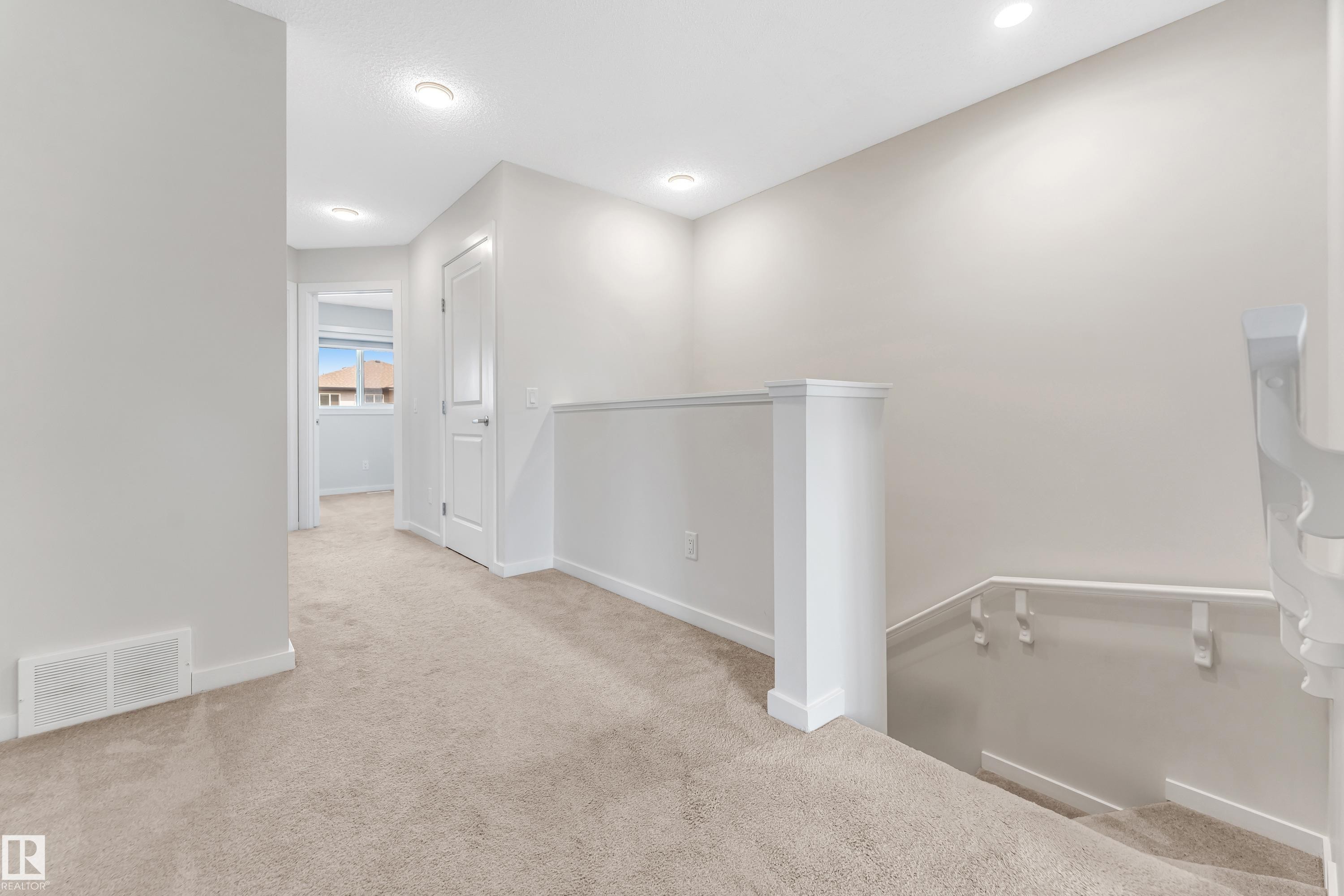 Hall featuring an upstairs landing and light carpet - 2095 Maple Road, Edmonton, AB - Indoor Photo Showing Other Room