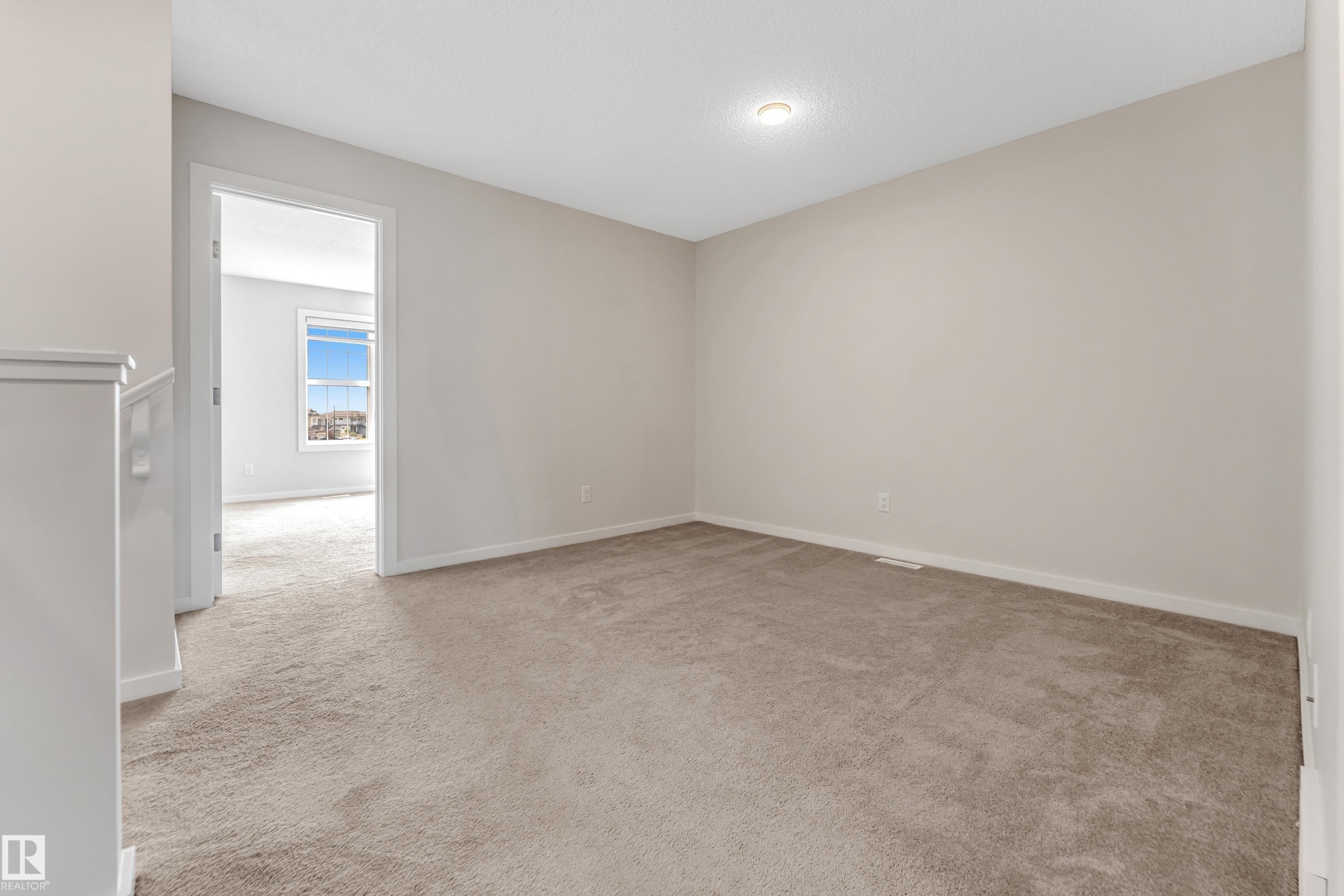Spare room with light colored carpet and baseboards - 2095 Maple Road, Edmonton, AB - Indoor Photo Showing Other Room