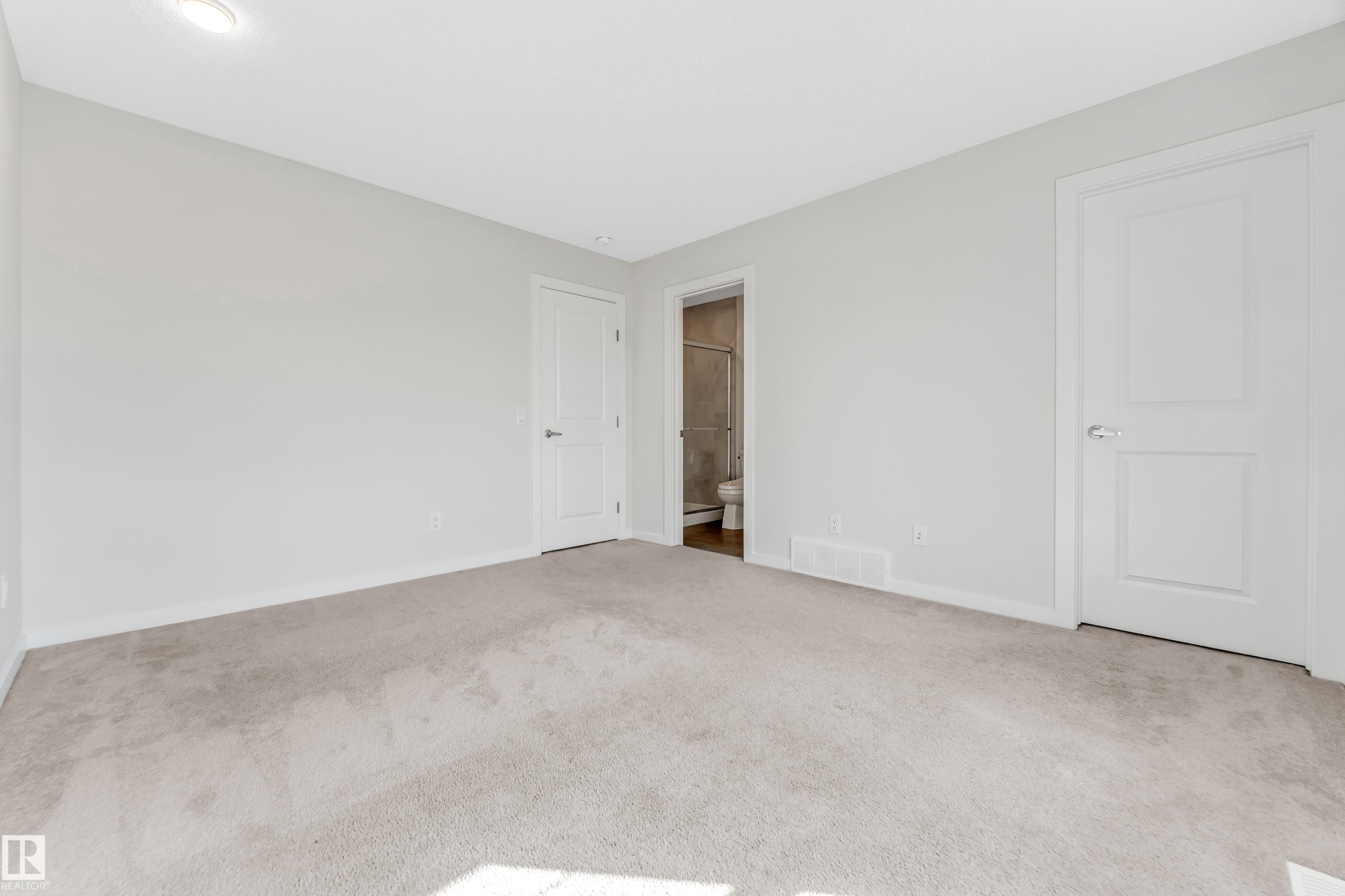 Unfurnished bedroom featuring carpet floors and ensuite bath - 2095 Maple Road, Edmonton, AB - Indoor Photo Showing Other Room