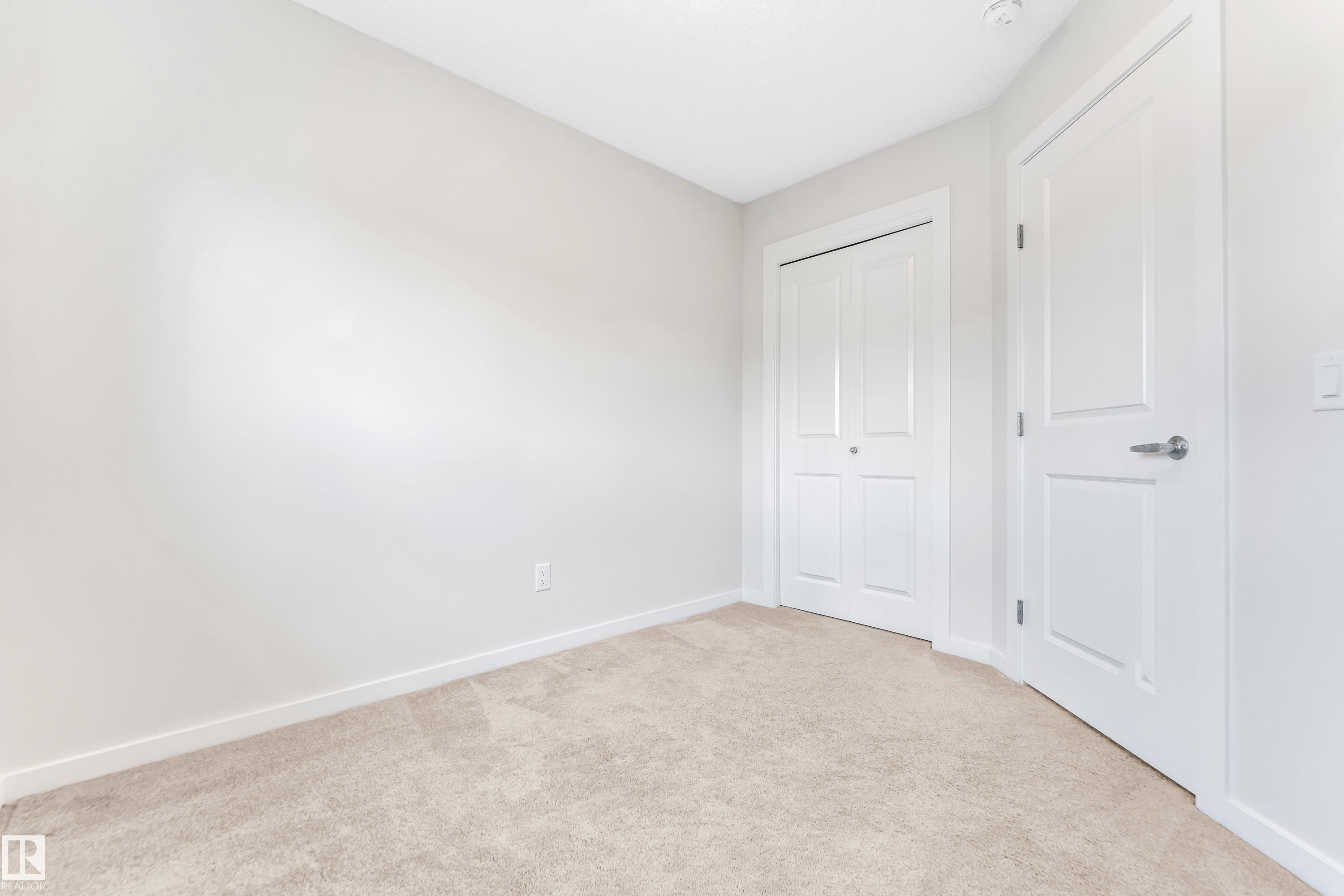 Unfurnished bedroom featuring light colored carpet and a closet - 2095 Maple Road, Edmonton, AB - Indoor Photo Showing Other Room