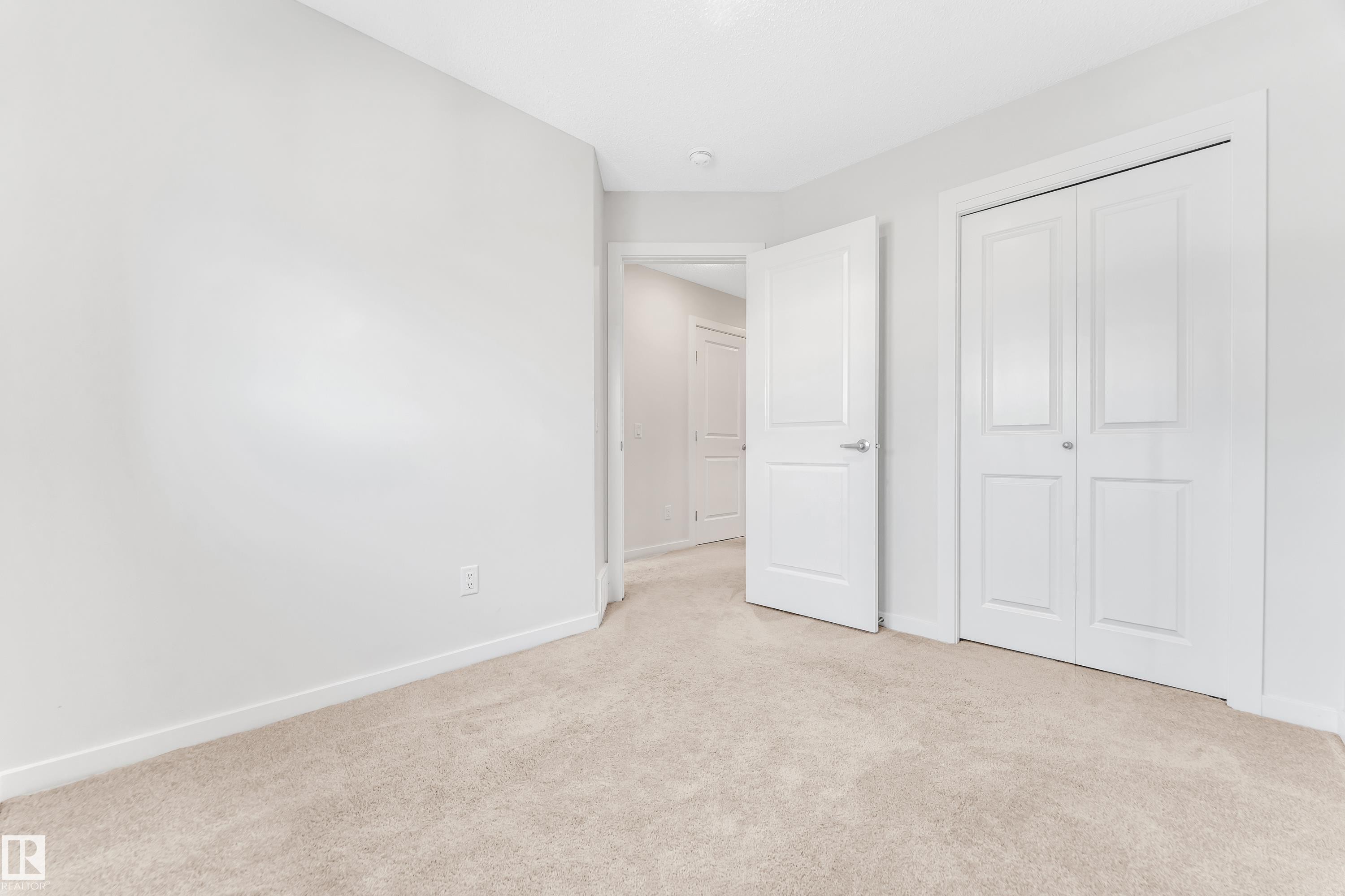 Unfurnished bedroom with light colored carpet and a closet - 2095 Maple Road, Edmonton, AB - Indoor Photo Showing Other Room