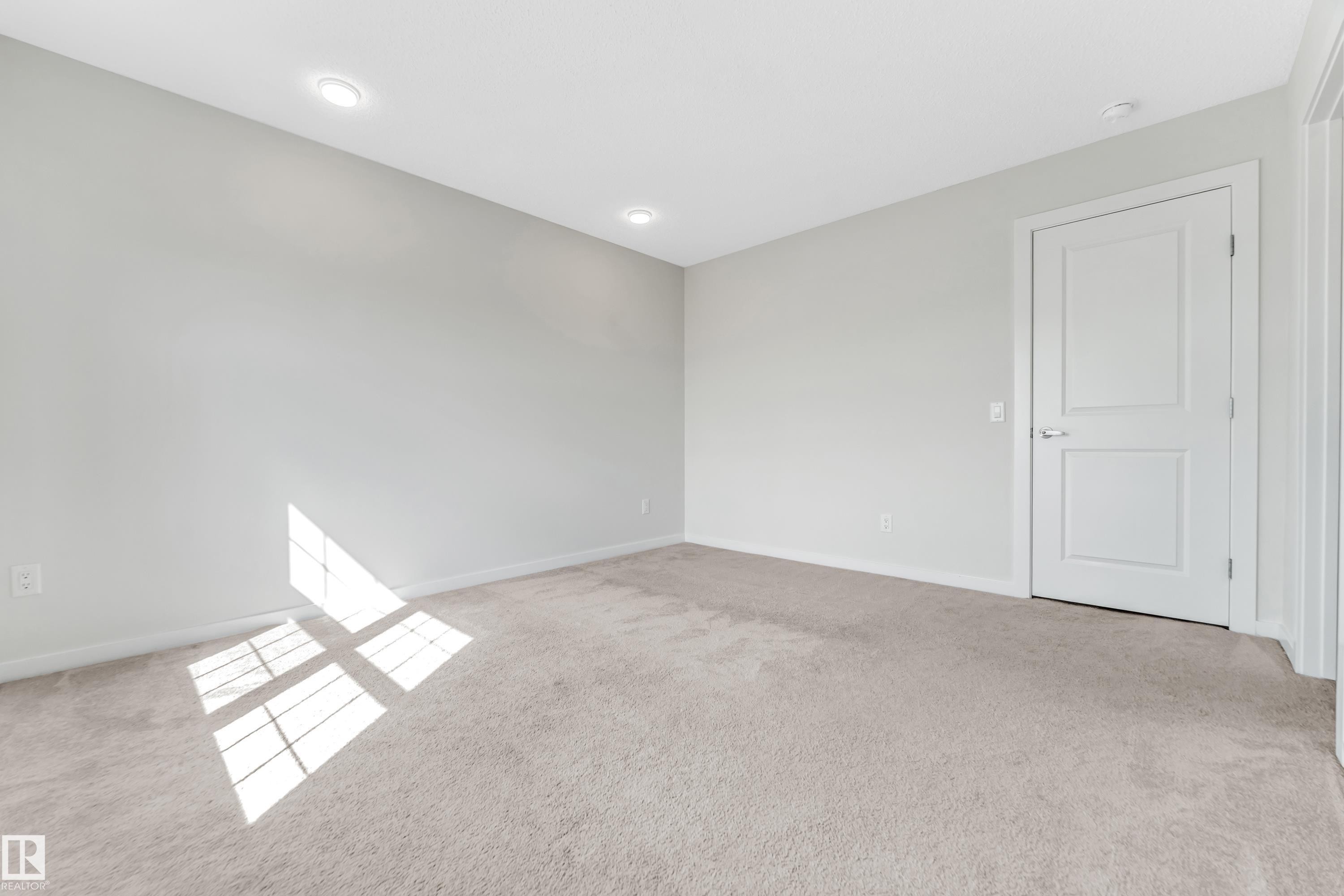 Spare room with light carpet and baseboards - 2095 Maple Road, Edmonton, AB - Indoor Photo Showing Other Room