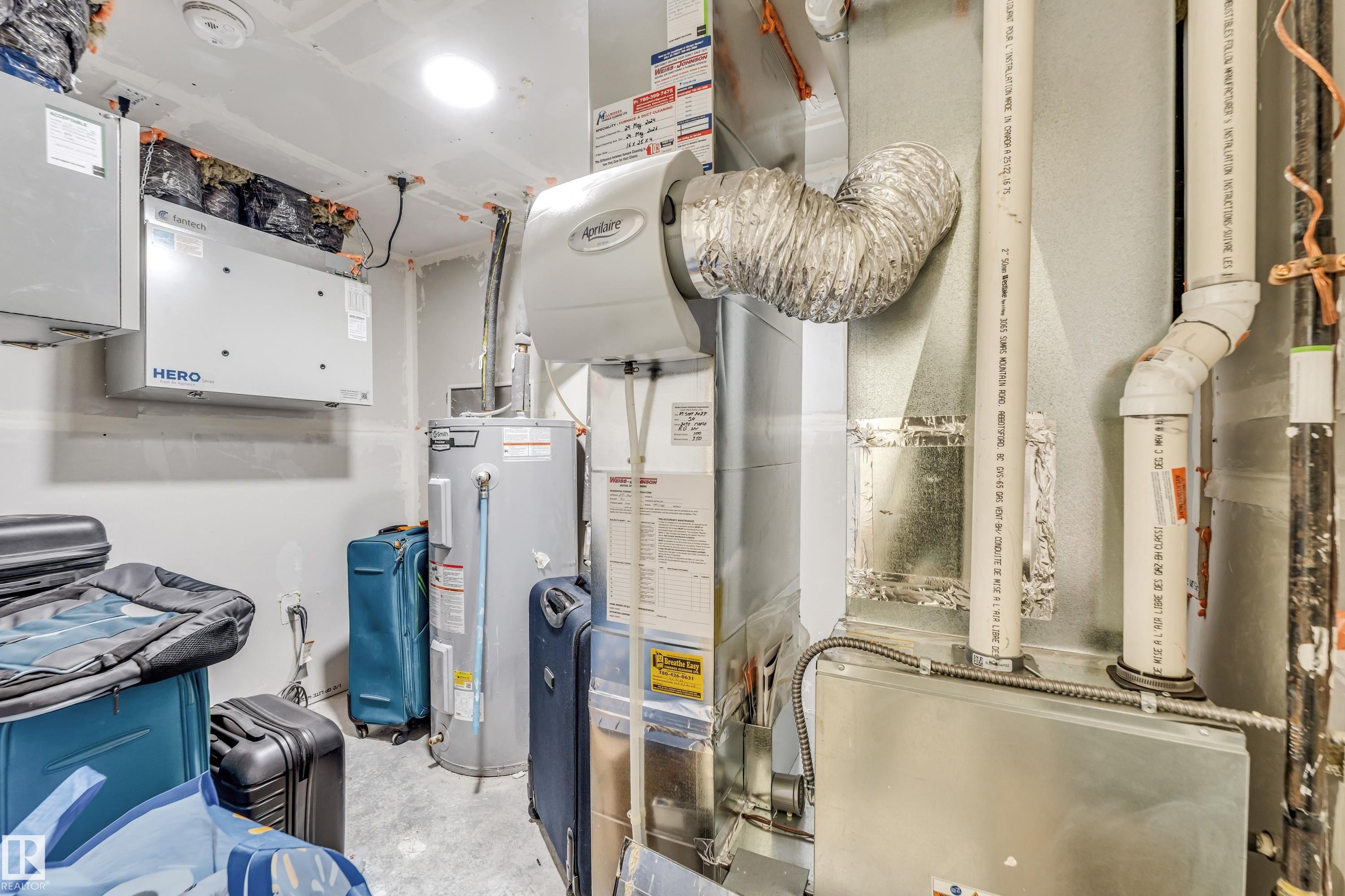 Utility room featuring water heater and heating unit - 2095 Maple Road, Edmonton, AB - Indoor Photo Showing Basement