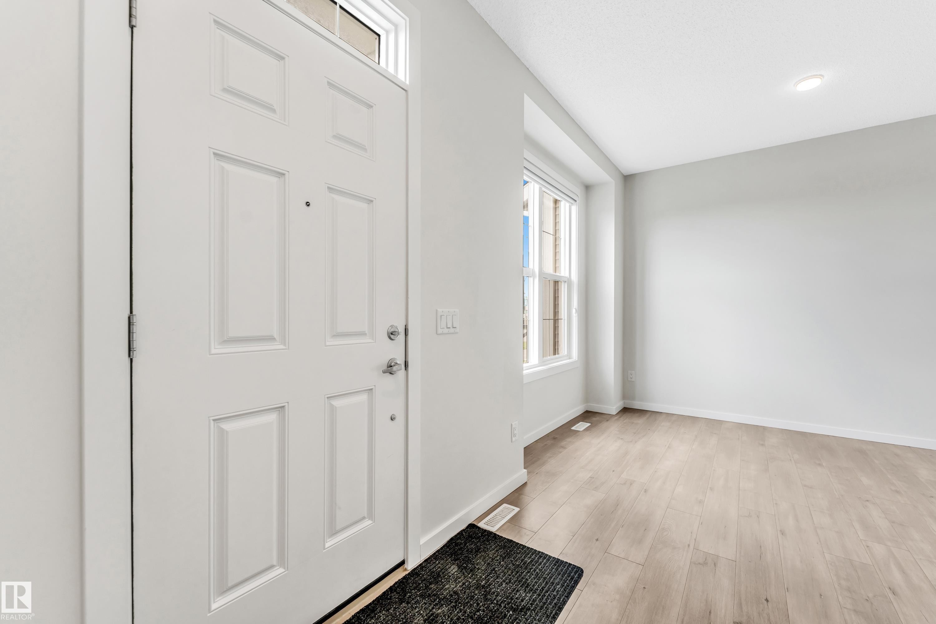 Entryway with light wood-style flooring and baseboards - 2095 Maple Road, Edmonton, AB - Indoor Photo Showing Other Room